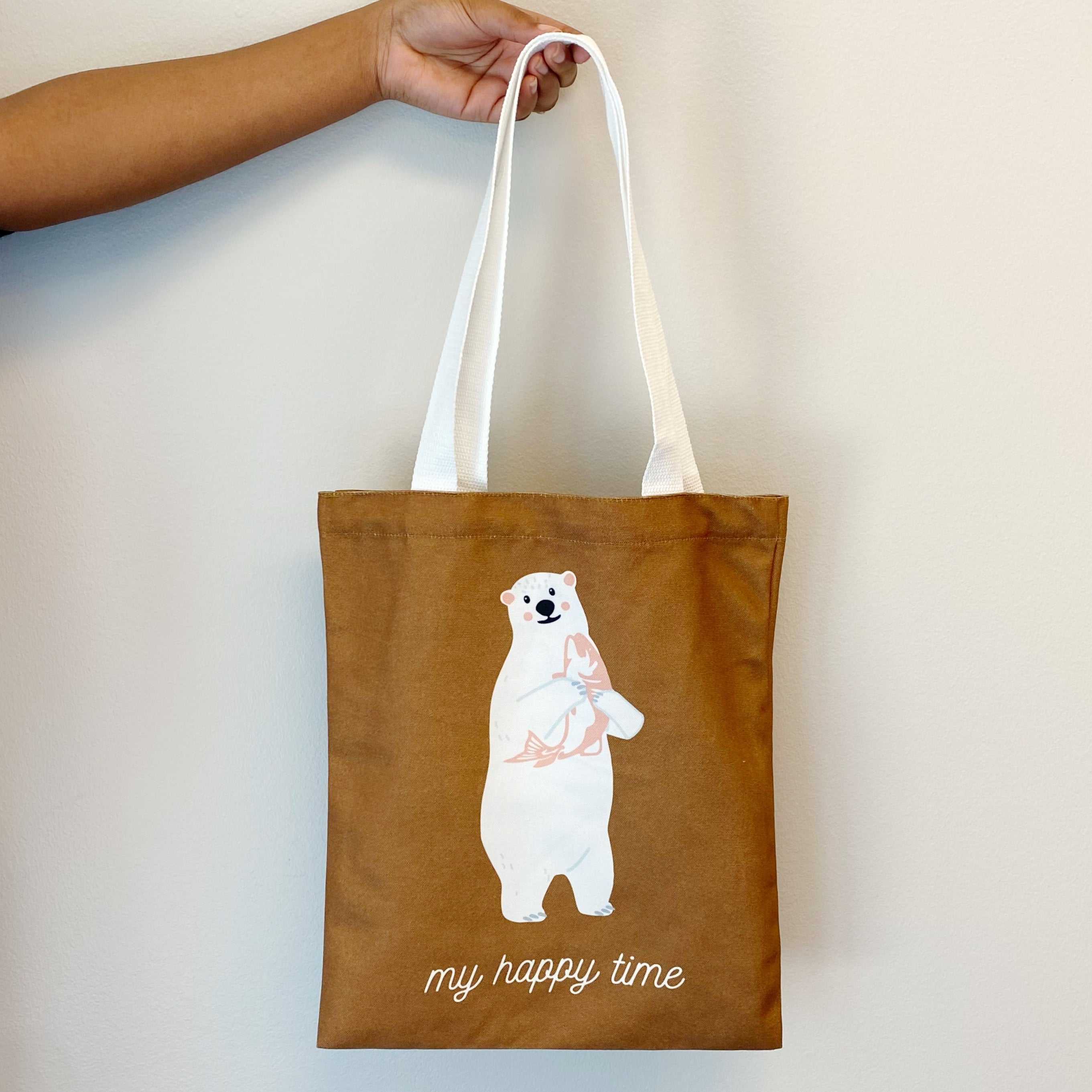 A stylish My Happy Canvas Tote featuring a positive graphic print, perfect for carrying books and small devices.