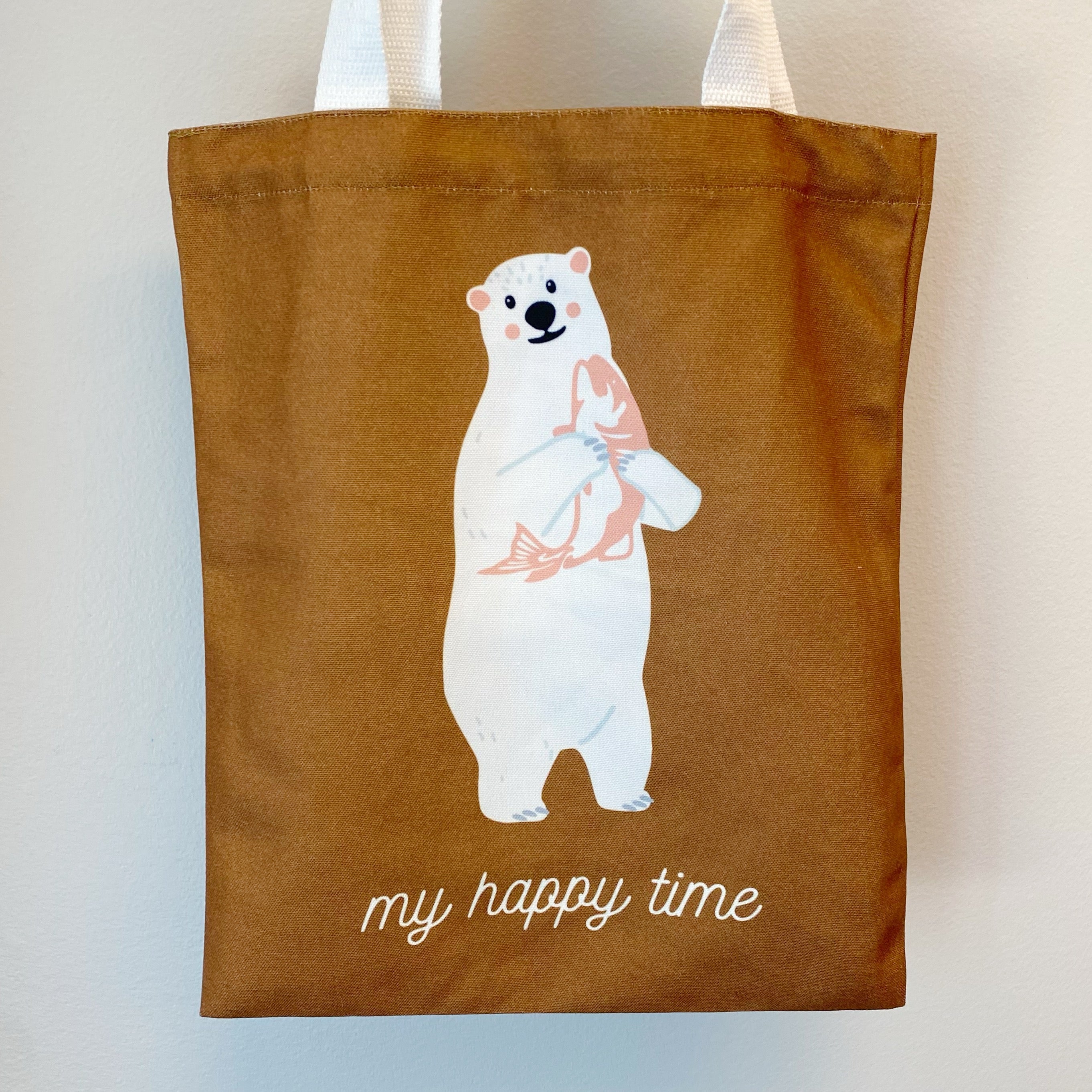 A stylish My Happy Canvas Tote featuring a positive graphic print, perfect for carrying books and small devices.