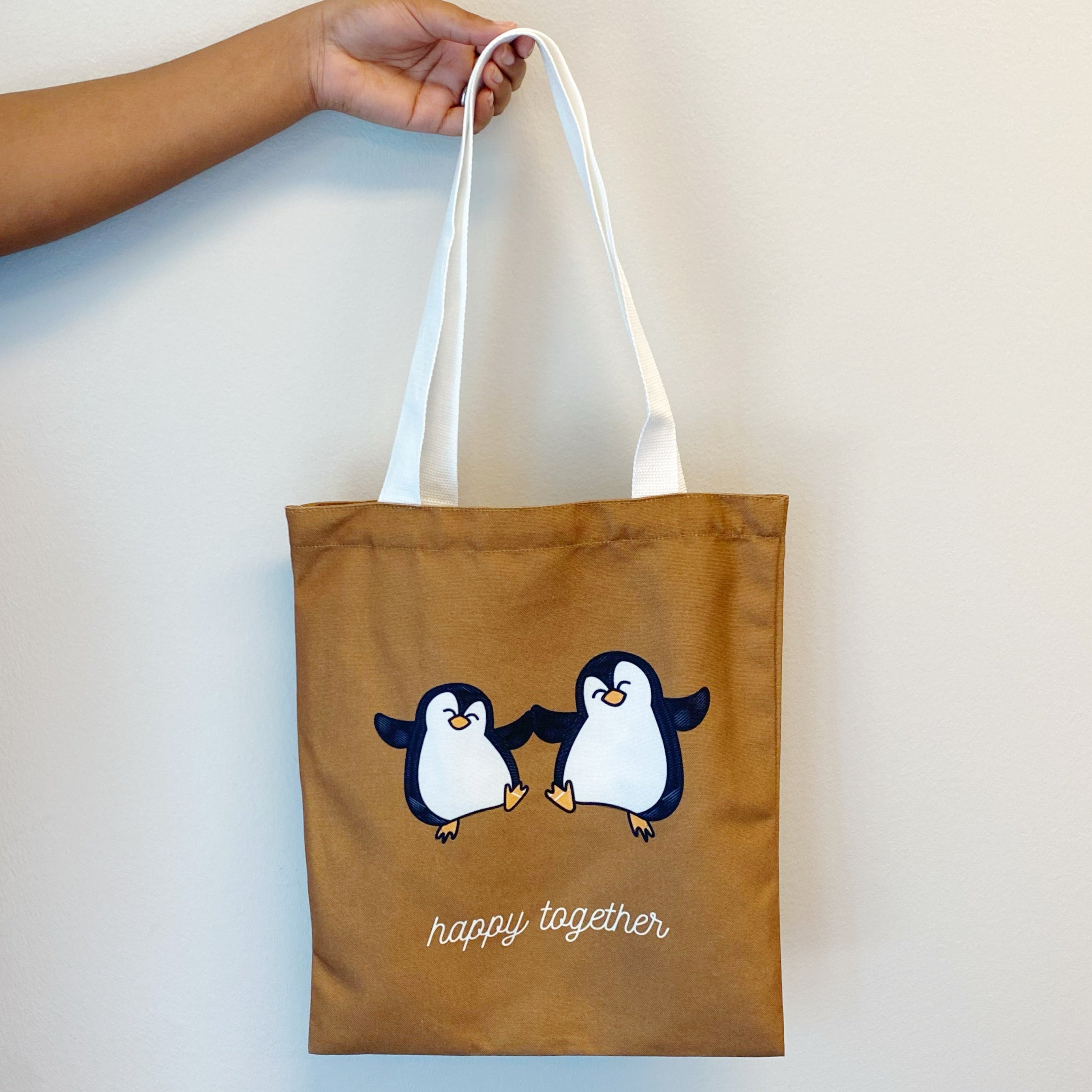 A stylish My Happy Canvas Tote featuring a positive graphic print, perfect for carrying books and small devices.