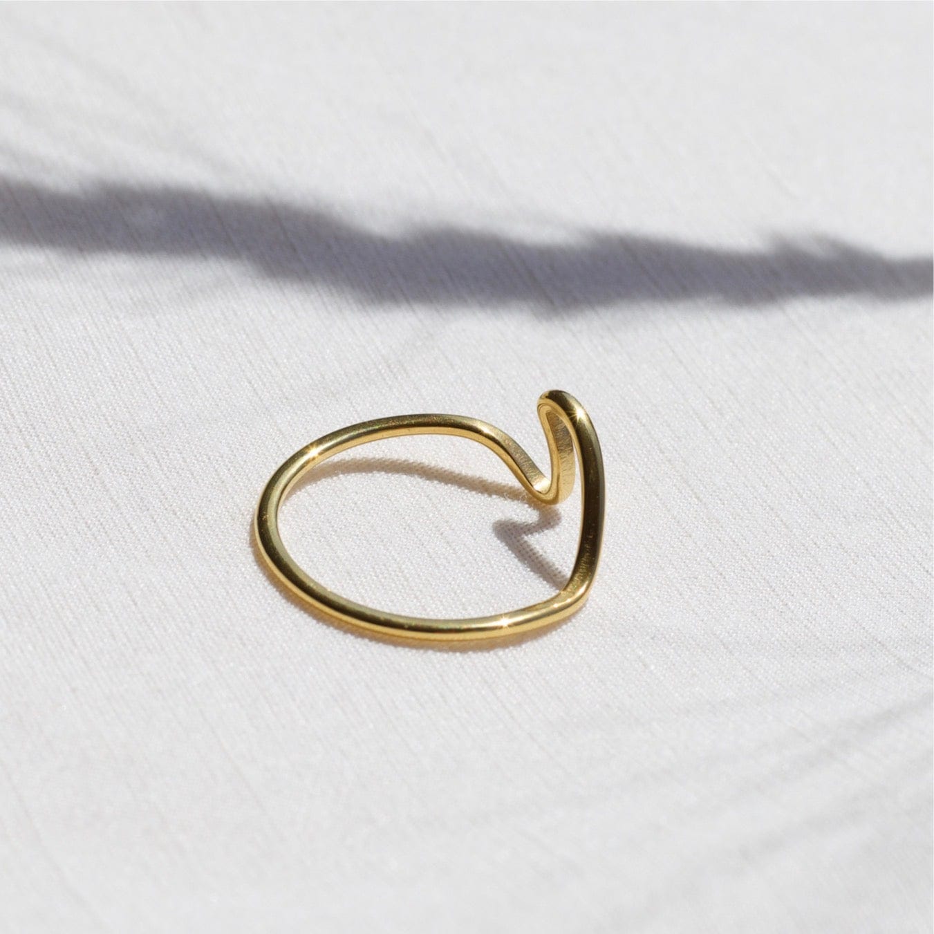 Mykonos Dainty Ocean Waved Line Stacking Ring in gold, showcasing its minimalist geometric design and cut-out wave line.