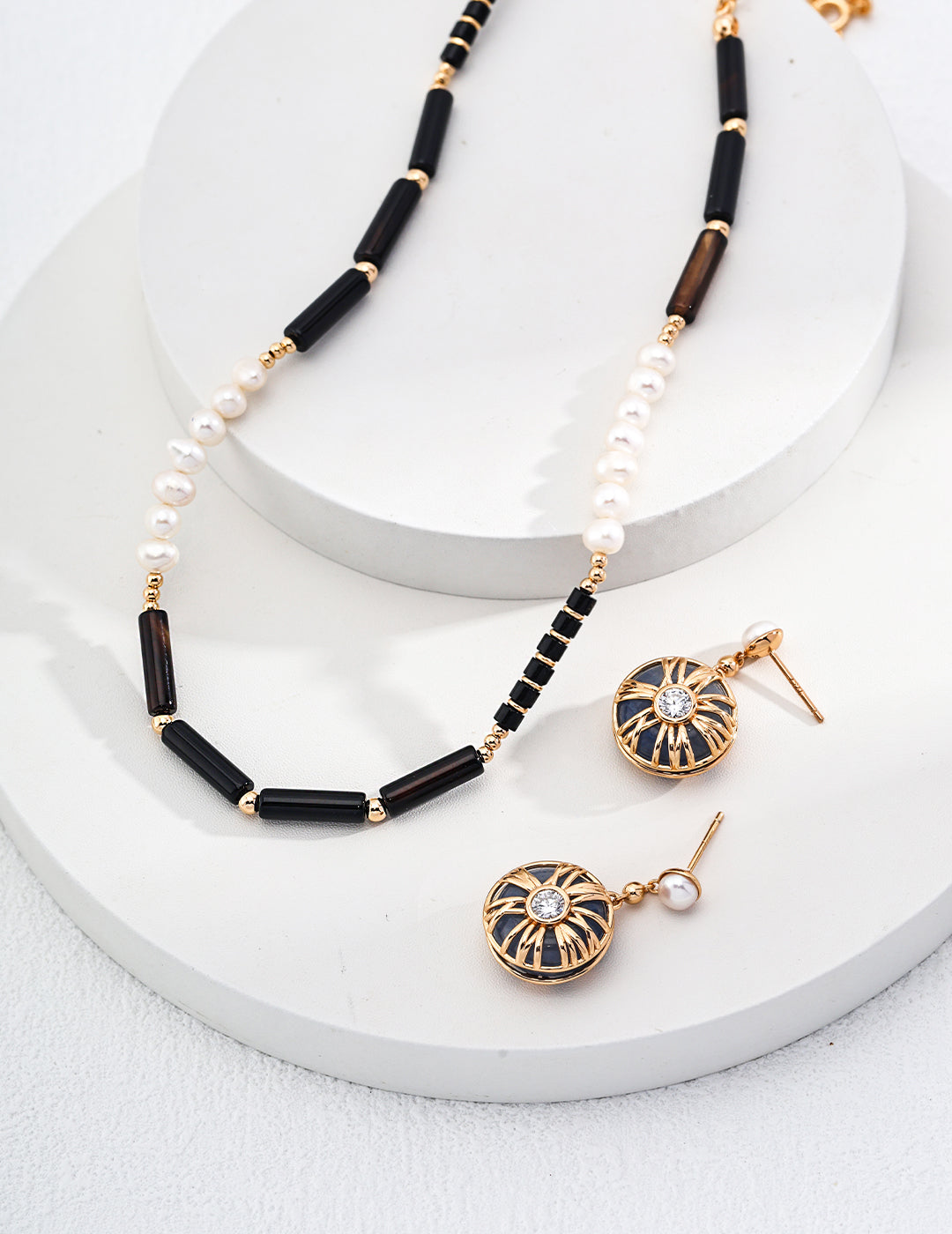 Mystic Night Black Pendant Pearl Earrings featuring elegant black pendants and lustrous pearls, showcasing a sophisticated design.