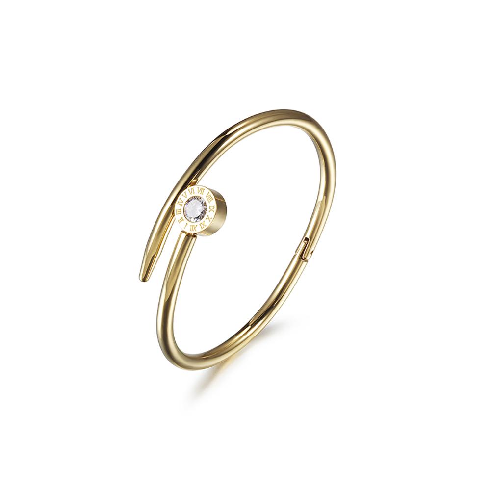 Elegant Nail Crossover Bangle made of stainless steel with gold plating, showcasing a modern design.