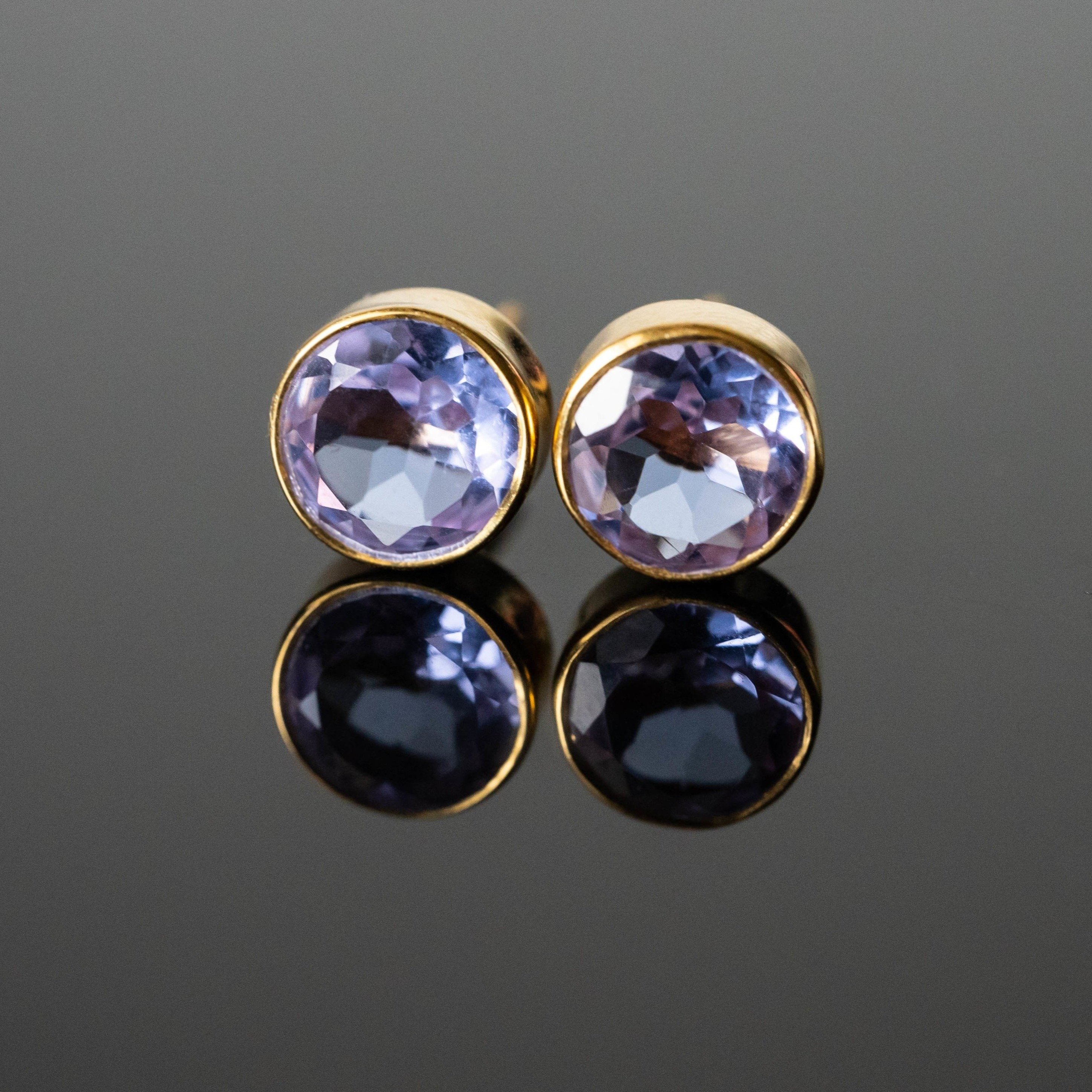 Lavender cubic zirconia round studs in gold-plated sterling silver, showcasing their elegant design and unique color.