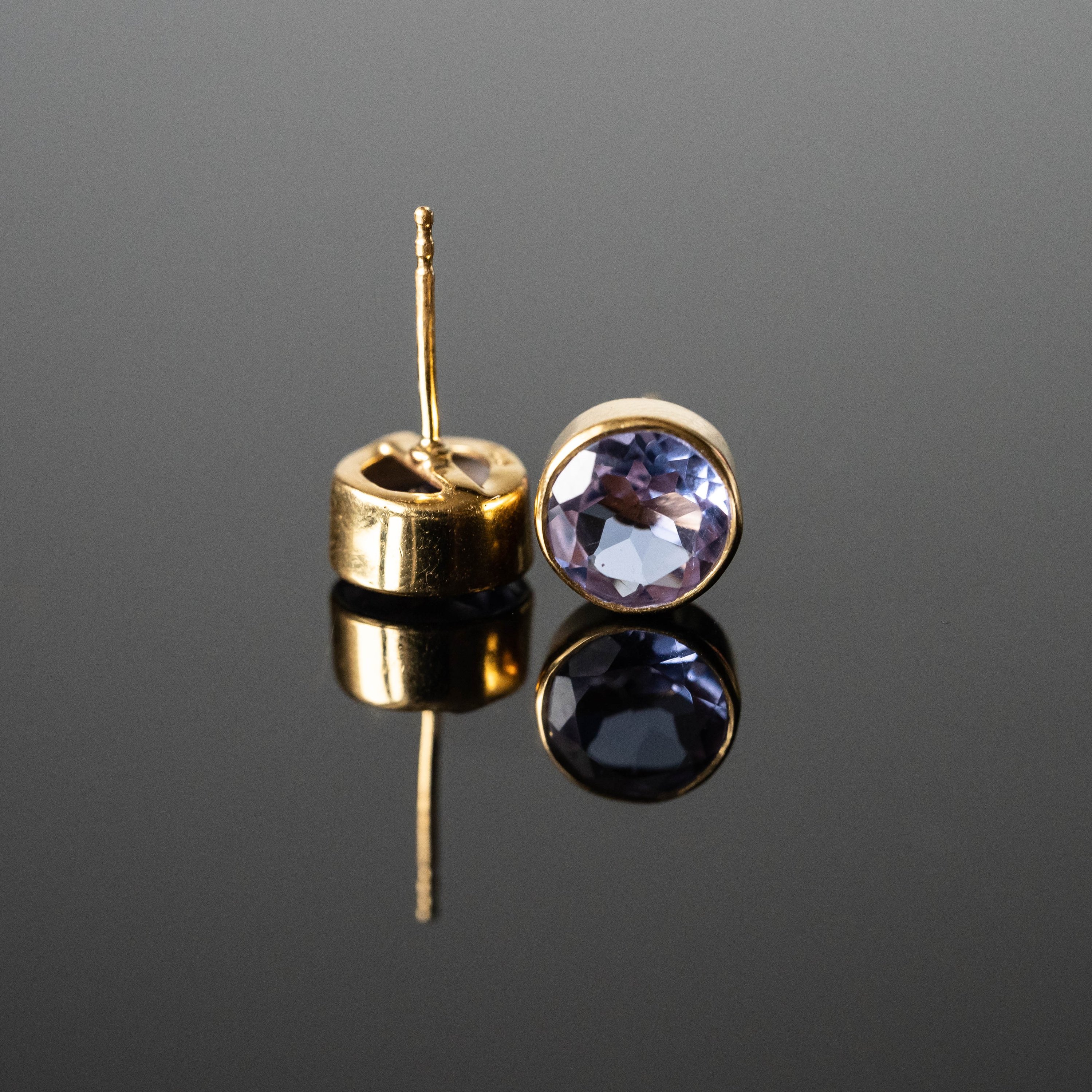 Lavender cubic zirconia round studs in gold-plated sterling silver, showcasing their elegant design and unique color.