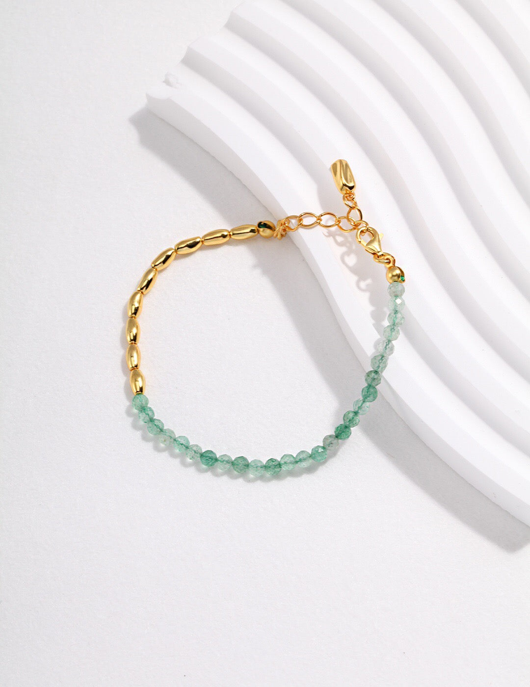 Natural Green Strawberry Crystal Bracelet featuring gold vermeil accents, handmade with hypoallergenic materials, displayed elegantly.