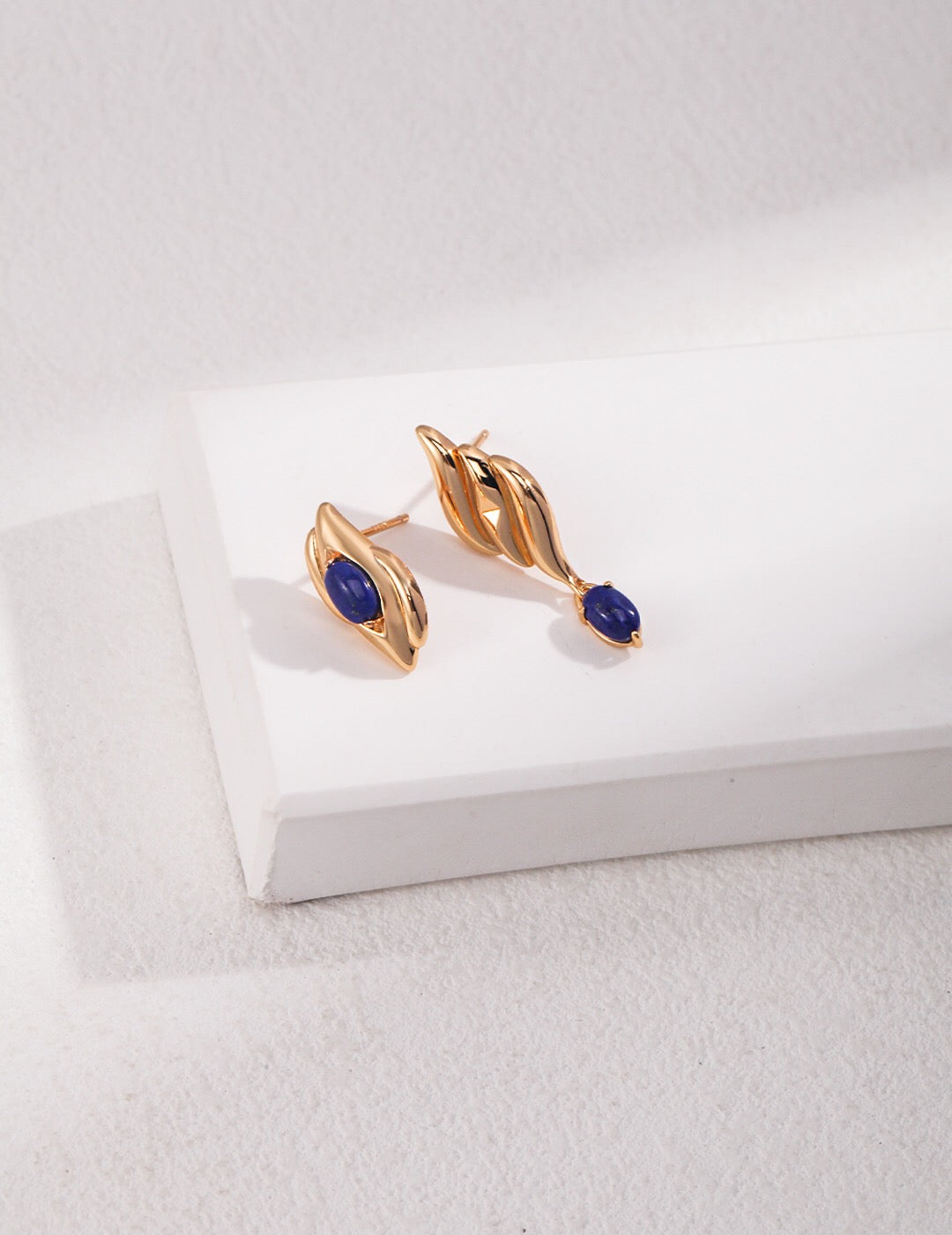 Handmade natural lapis lazuli asymmetrical earrings with gold vermeil, showcasing unique blue stones and elegant design.