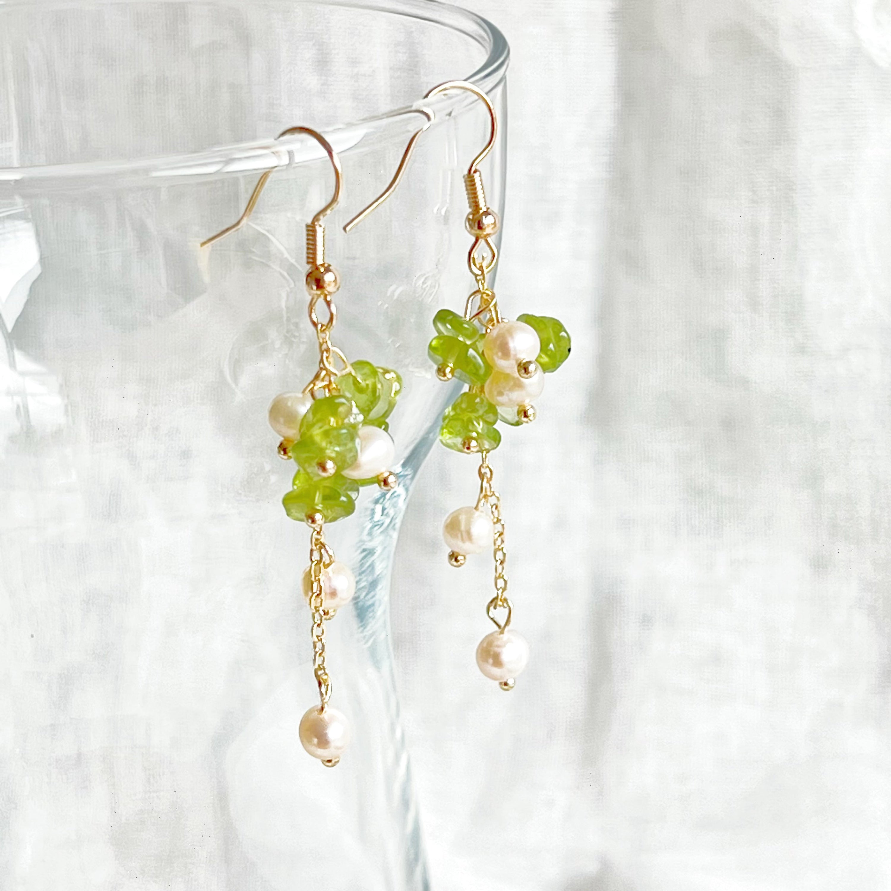 Natural peridot and pearl drop earrings featuring sterling silver ear wire, showcasing unique green gemstones and baroque freshwater pearls.