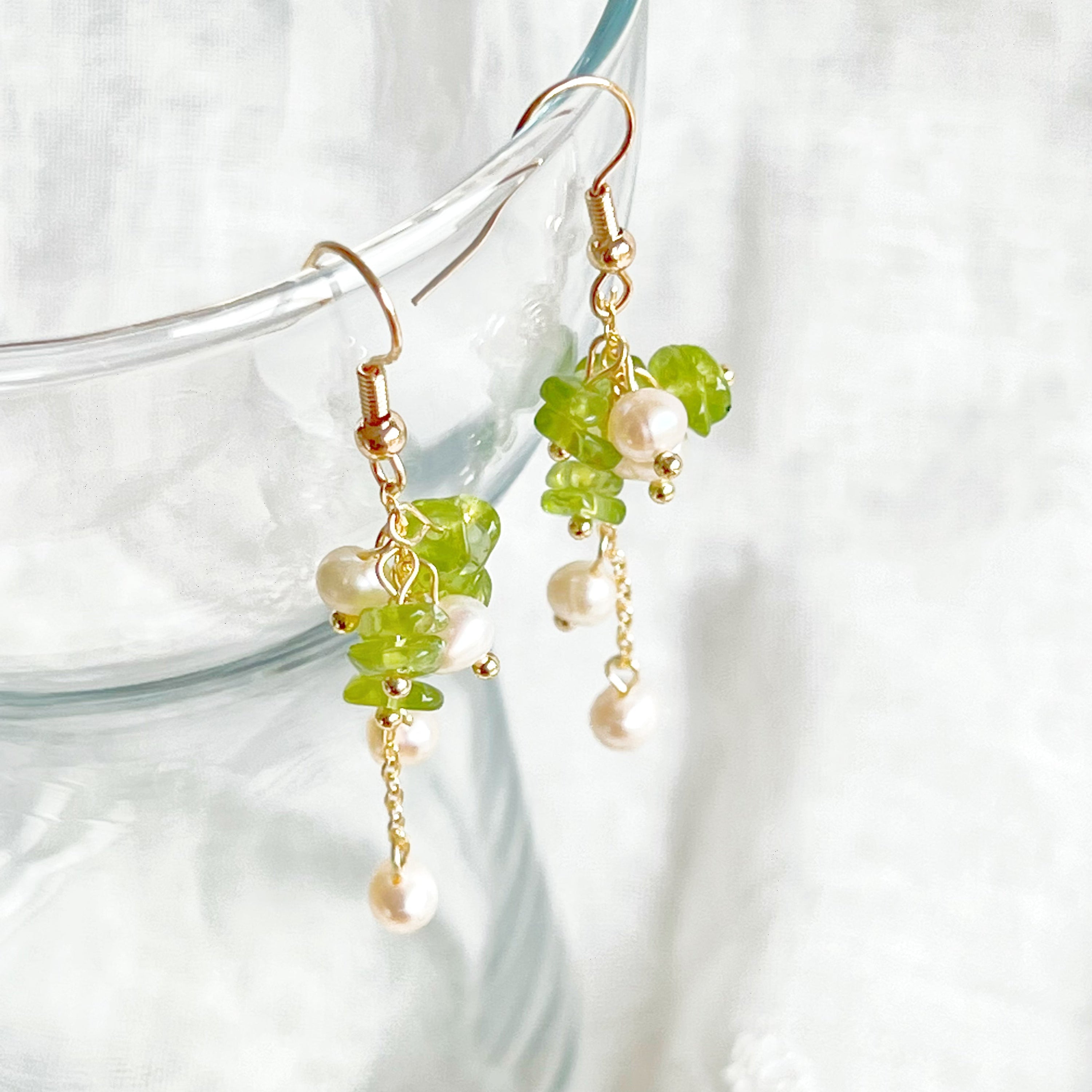 Natural peridot and pearl drop earrings featuring sterling silver ear wire, showcasing unique green gemstones and baroque freshwater pearls.