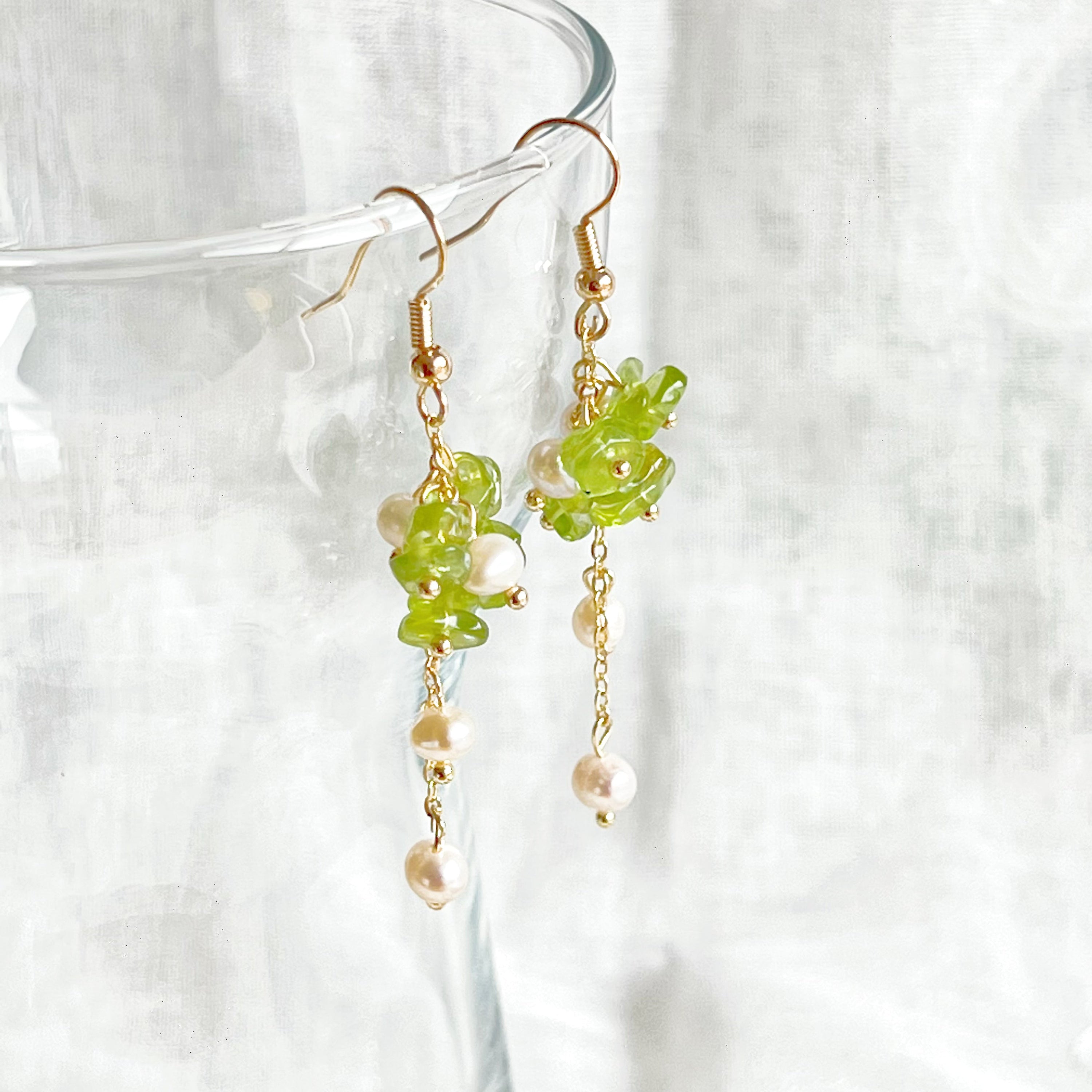 Natural peridot and pearl drop earrings featuring sterling silver ear wire, showcasing unique green gemstones and baroque freshwater pearls.