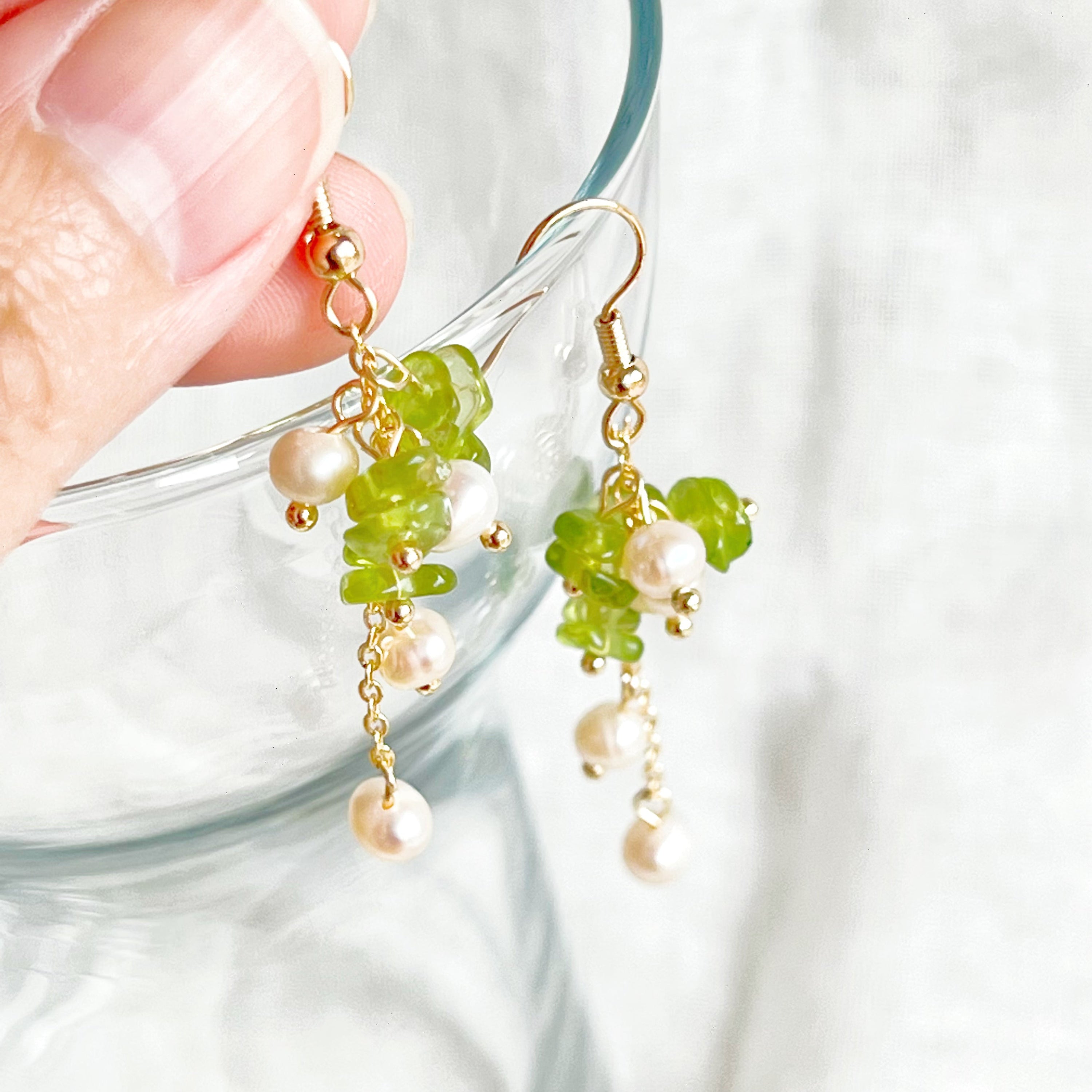 Natural peridot and pearl drop earrings featuring sterling silver ear wire, showcasing unique green gemstones and baroque freshwater pearls.