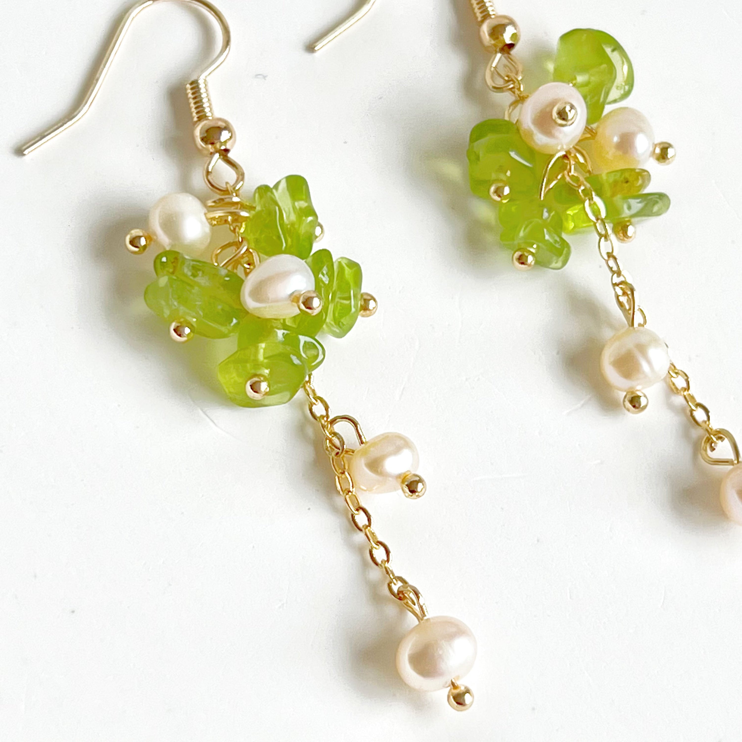 Natural peridot and pearl drop earrings featuring sterling silver ear wire, showcasing unique green gemstones and baroque freshwater pearls.