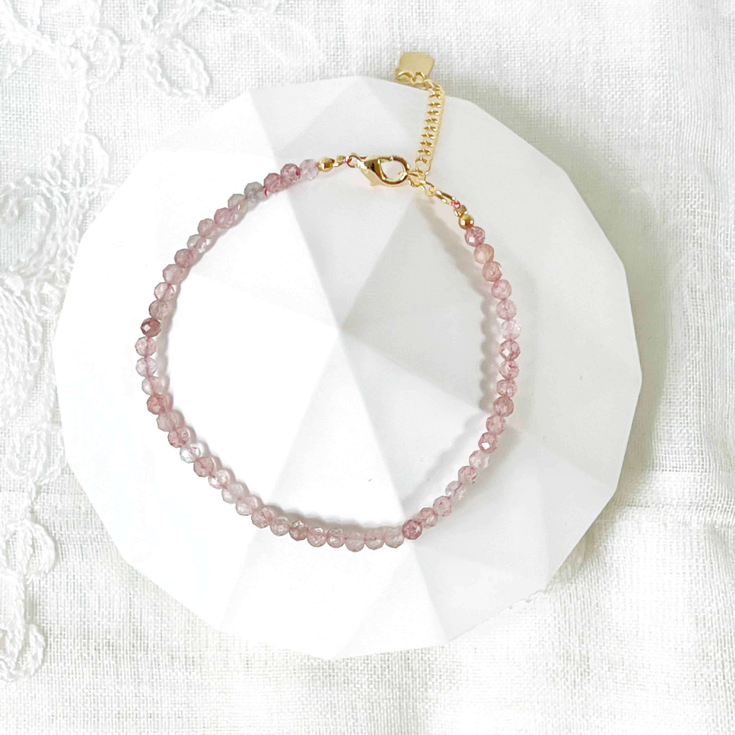 Natural Strawberry Quartz Beaded Bracelet with gold plated bronze buckle, showcasing unique pink beads.