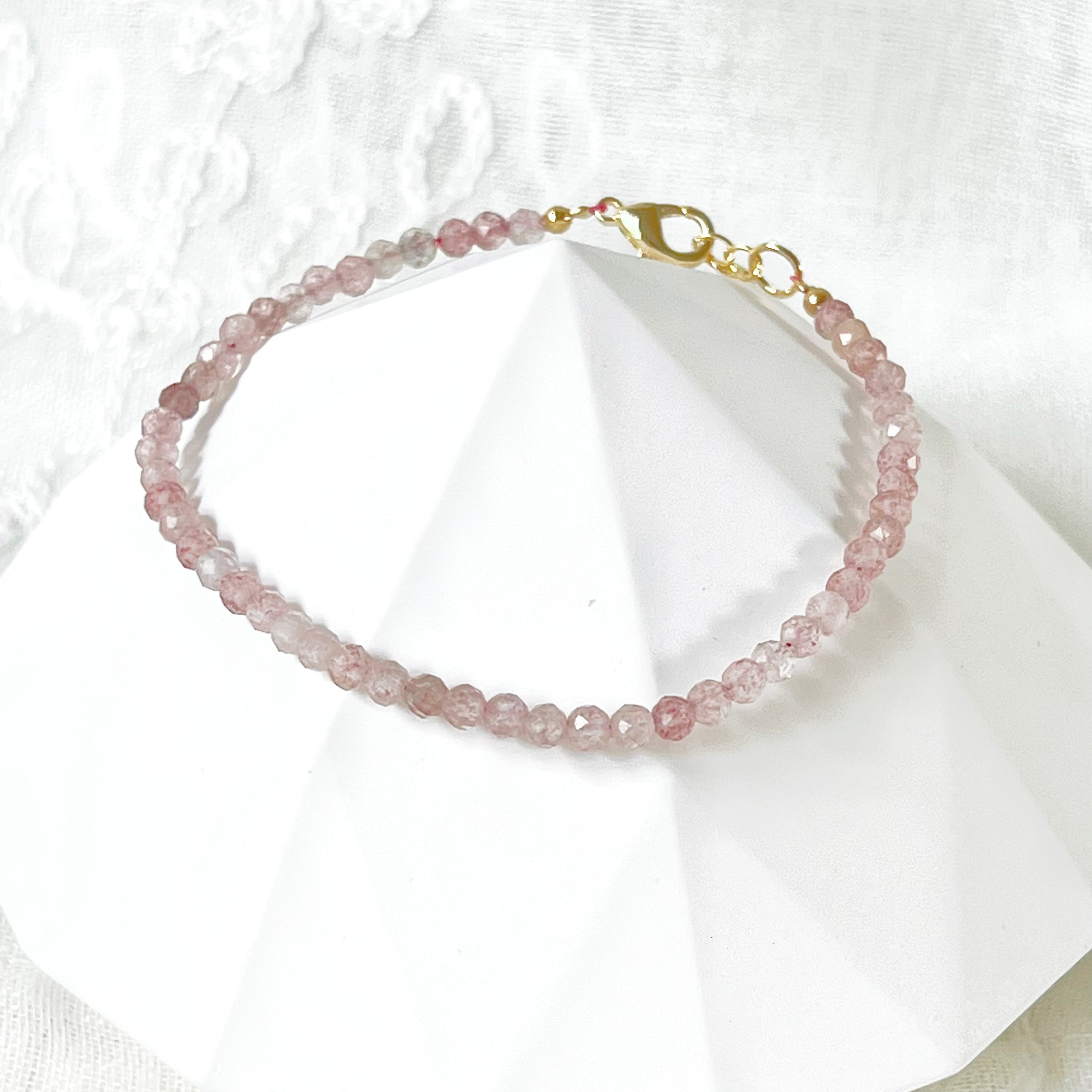 Natural Strawberry Quartz Beaded Bracelet with gold plated bronze buckle, showcasing unique pink beads.