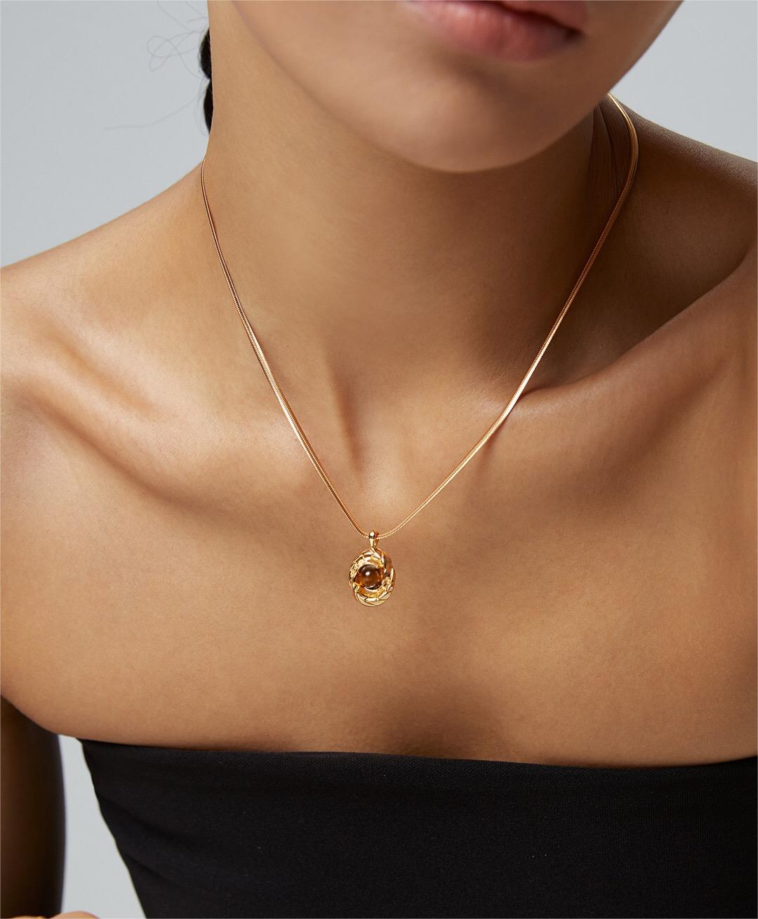 Natural Tiger Eye and Obsidian Pendant Bone Necklace featuring gold vermeil chain, showcasing the unique stones and craftsmanship.