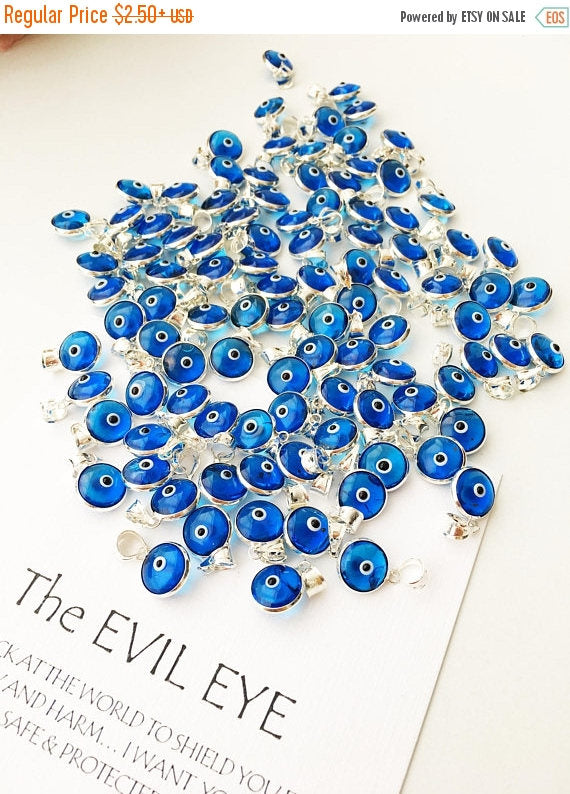 Navy blue evil eye charm featuring a tiny glass bead and silver-plated brass pendant, symbolizing protection and good luck.