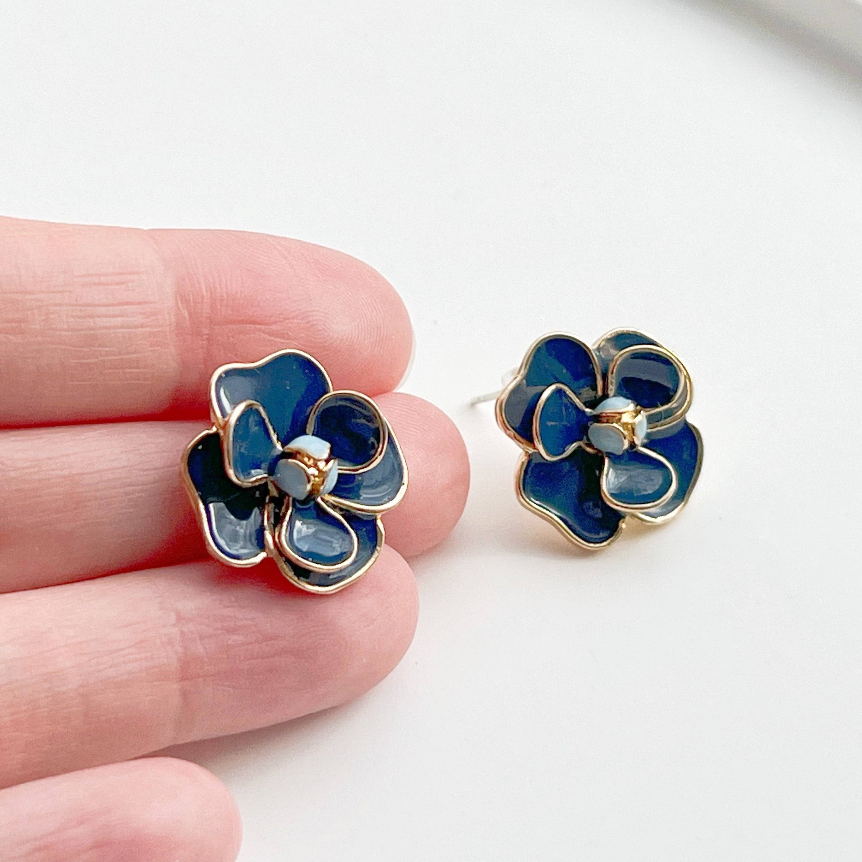 Navy blue rose earrings in flower shape, crafted from sterling silver and gold-plated bronze, displayed elegantly in a gift box.