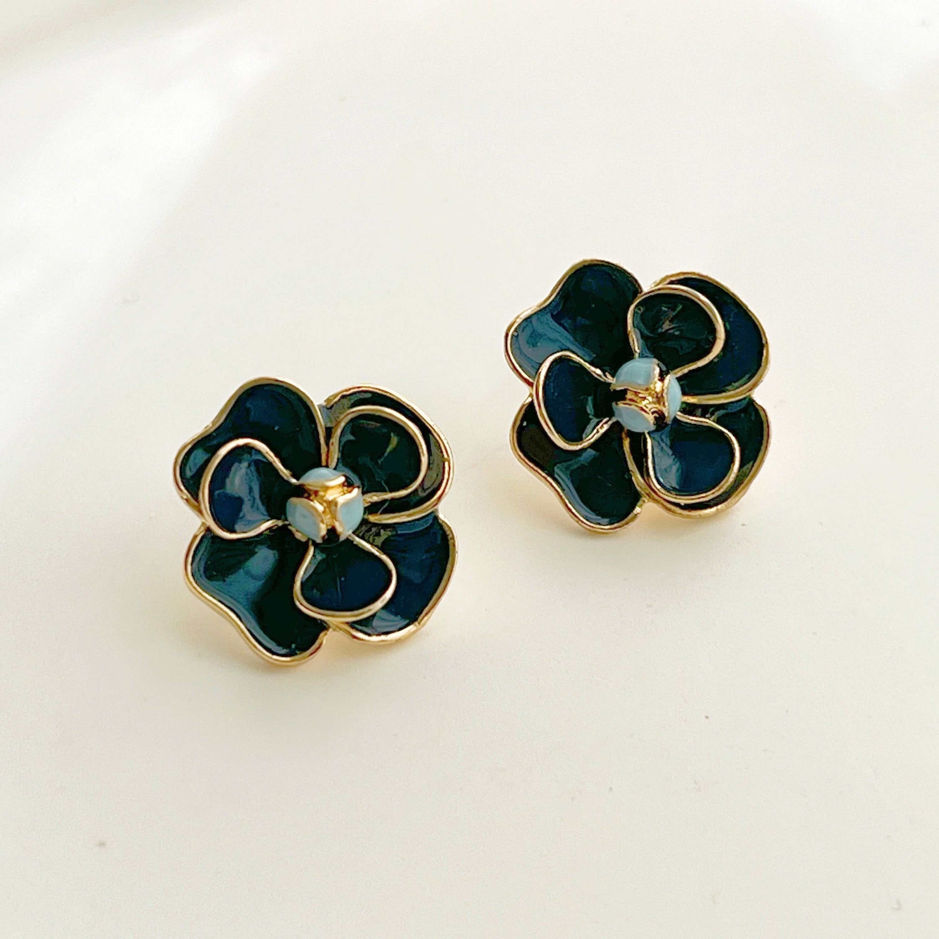 Navy blue rose earrings in flower shape, crafted from sterling silver and gold-plated bronze, displayed elegantly in a gift box.