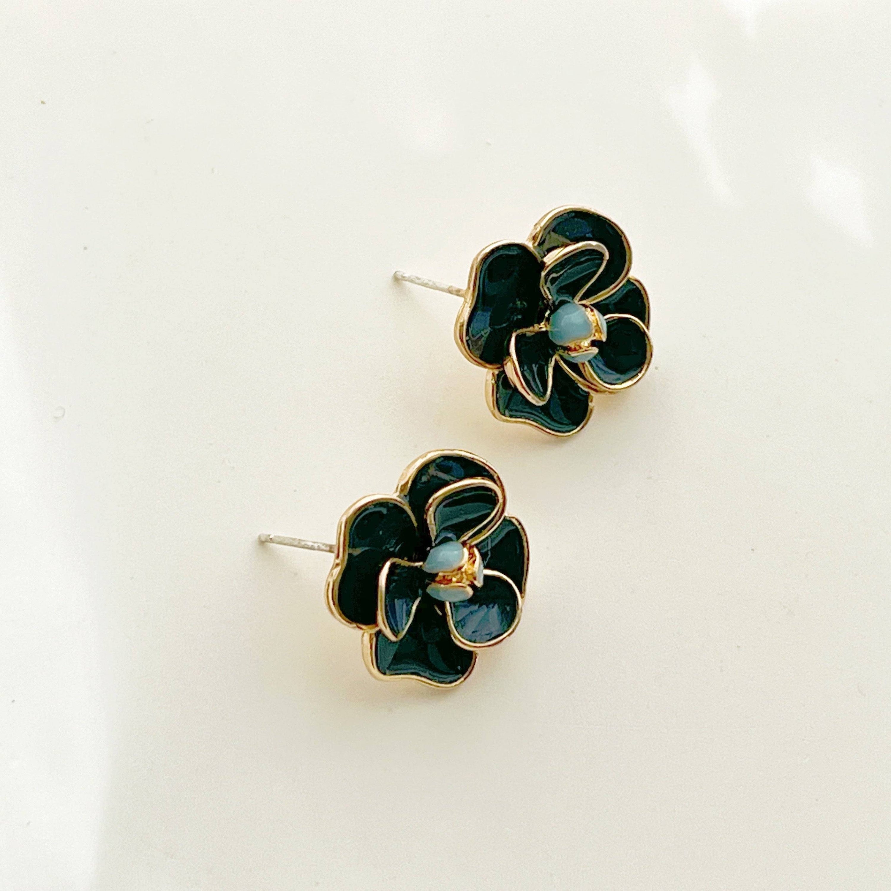 Navy blue rose earrings in flower shape, crafted from sterling silver and gold-plated bronze, displayed elegantly in a gift box.