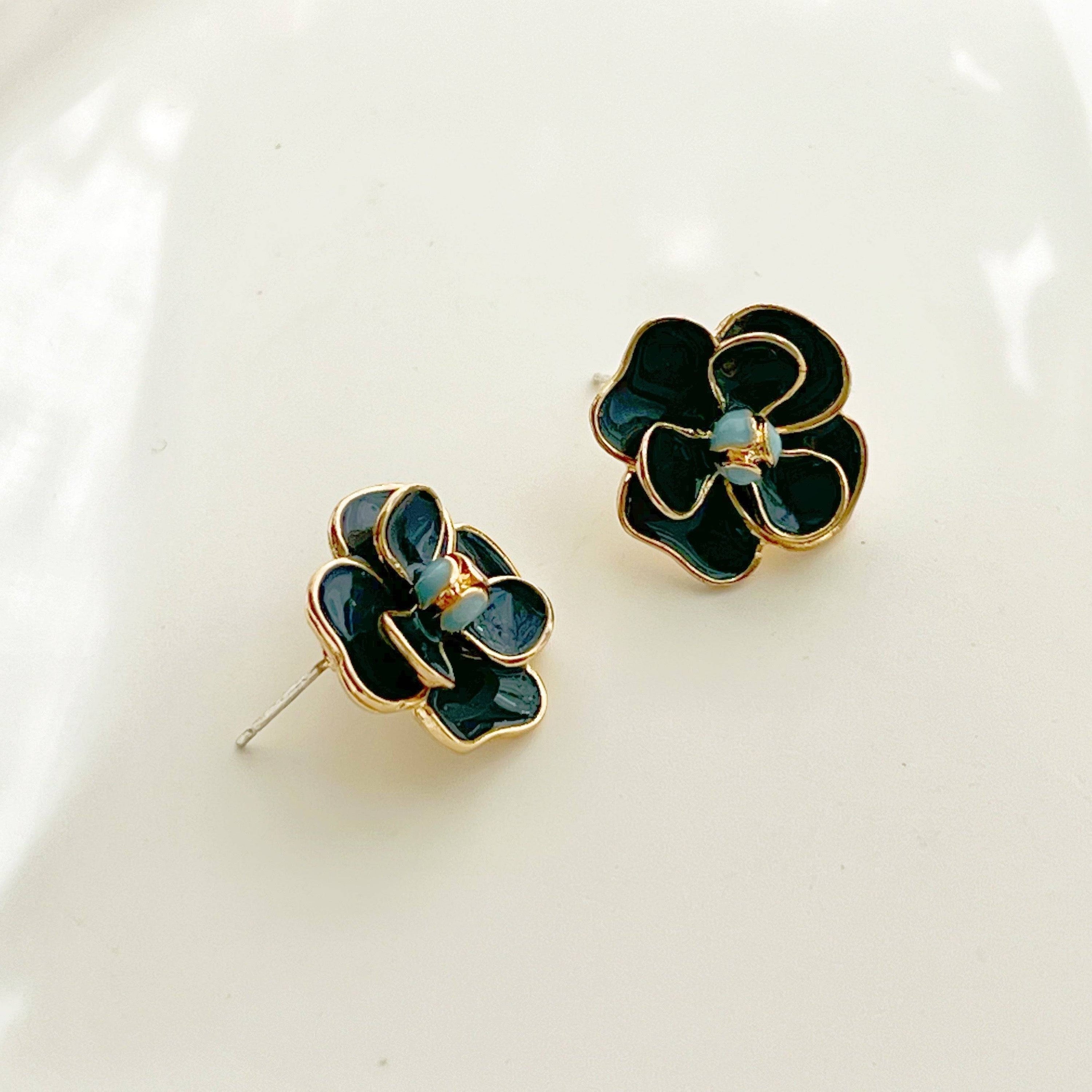 Navy blue rose earrings in flower shape, crafted from sterling silver and gold-plated bronze, displayed elegantly in a gift box.