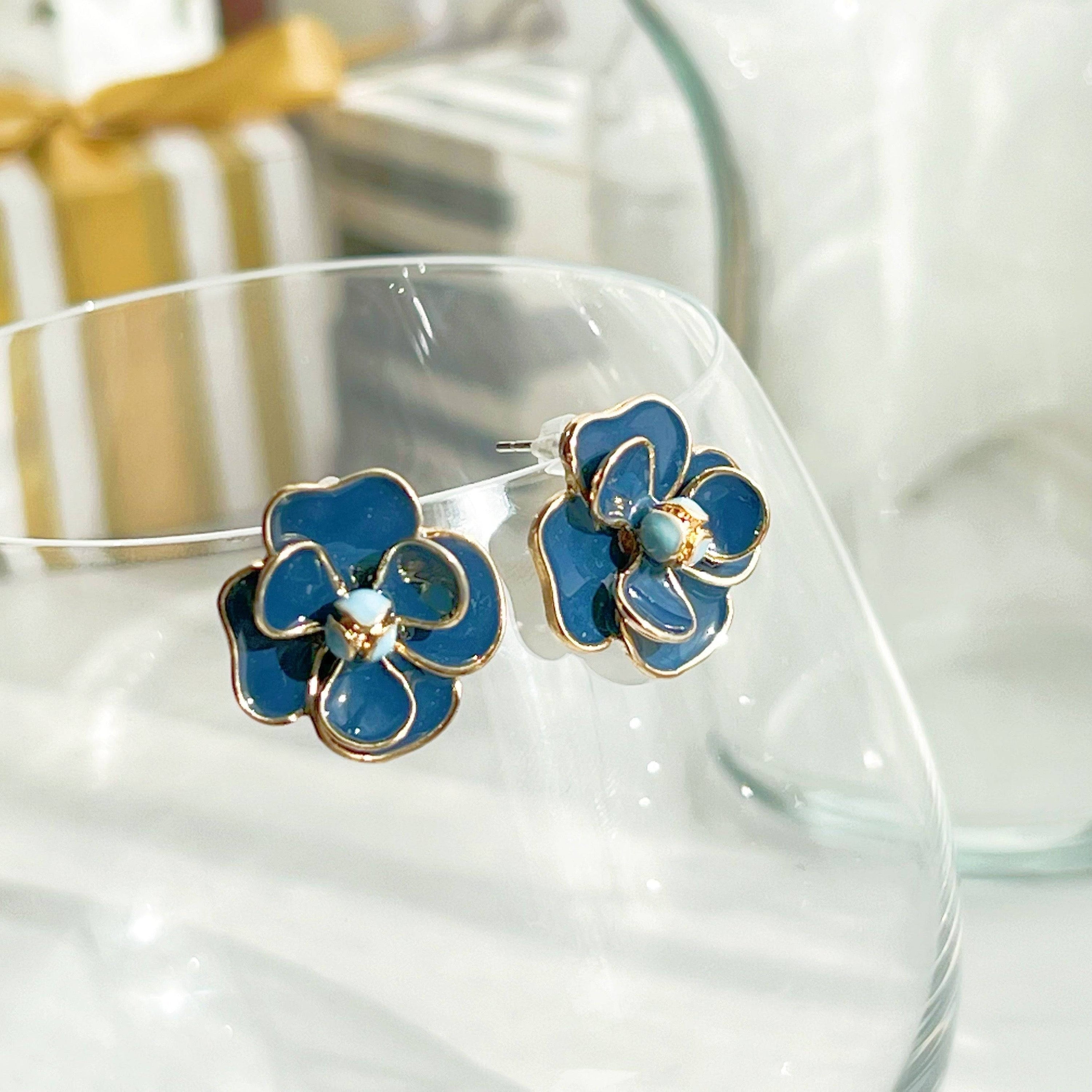 Navy blue rose earrings in flower shape, crafted from sterling silver and gold-plated bronze, displayed elegantly in a gift box.