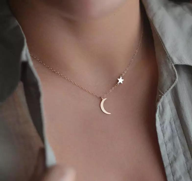 New Moon Necklace featuring a moon charm and side-hanging star on a 16-inch chain with extender.