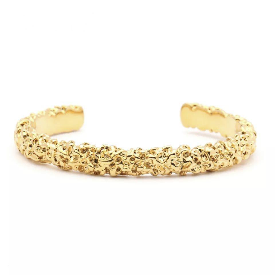 Nicole Cuff bracelet featuring a hammered design with 18k gold plating, showcasing elegance and style.