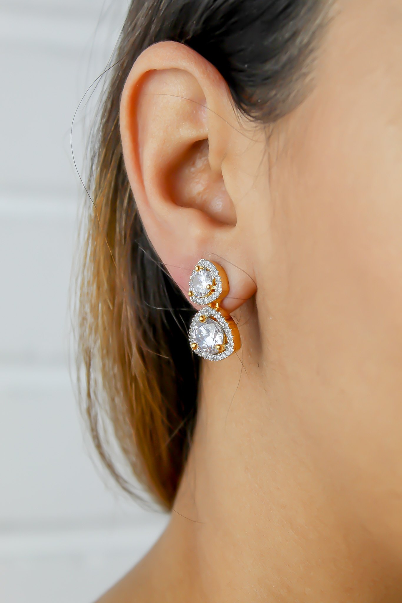 Elegant Nikobar Stone Earrings featuring gold plating and sparkling crystals, inspired by the Nikobar archipelago.