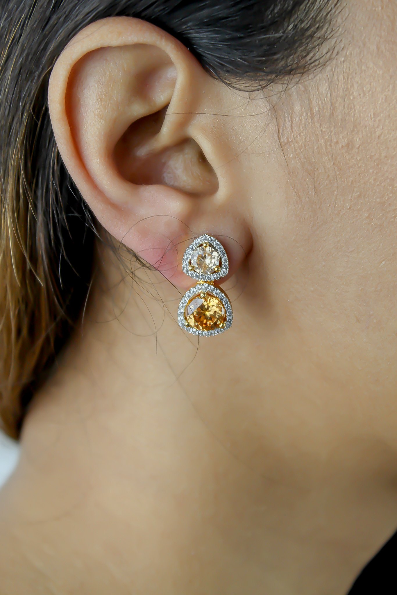 Elegant Nikobar Stone Earrings featuring gold plating and sparkling crystals, inspired by the Nikobar archipelago.