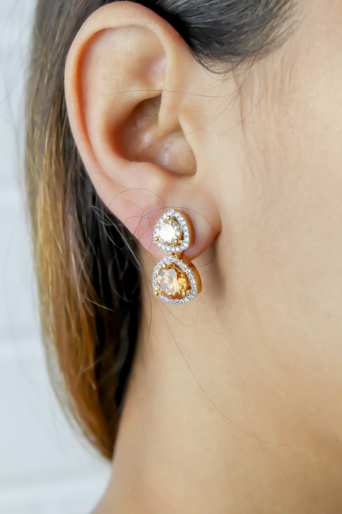 Elegant Nikobar Stone Earrings featuring gold plating and sparkling crystals, inspired by the Nikobar archipelago.