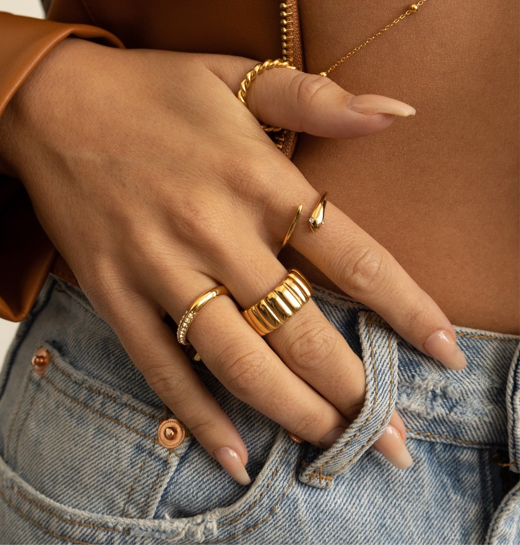 A stylish Nile Snake Ring featuring a thin wrapped band with cubic zirconia stones, elegantly designed for edgy fashion.