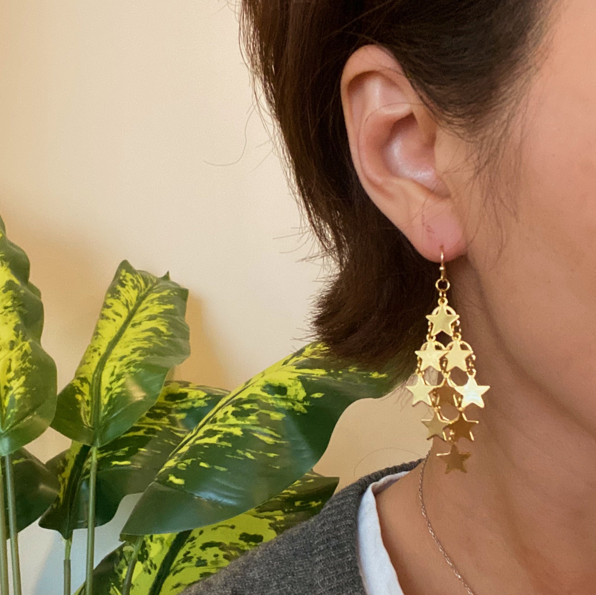 Nine Stars Lined Chandelier Earrings featuring golden stars and delicate draping, elegantly designed for a sophisticated look.