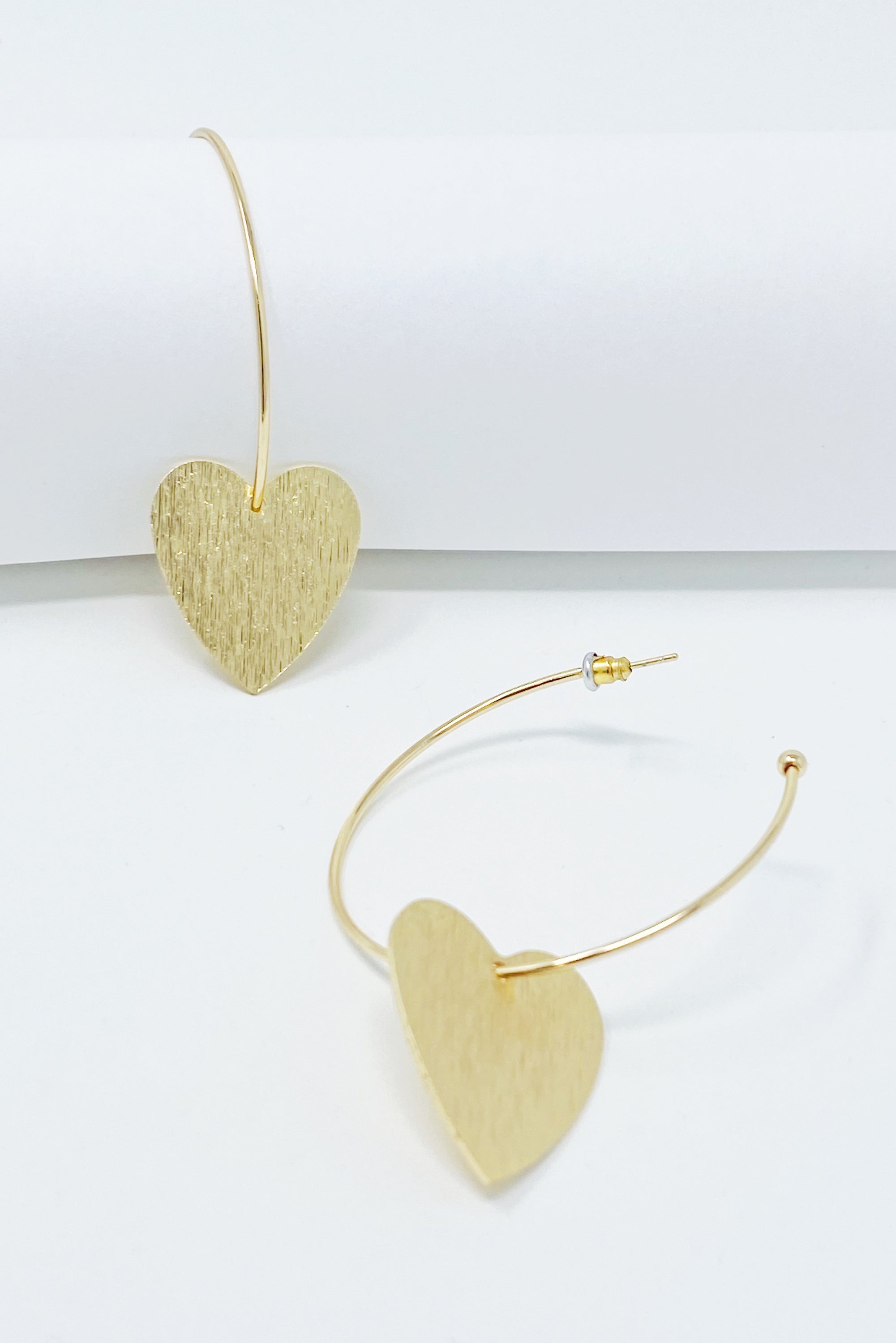 Stylish No Games Heart Hoop Earrings featuring a brushed texture heart pendant on a slim gold plated brass hoop.