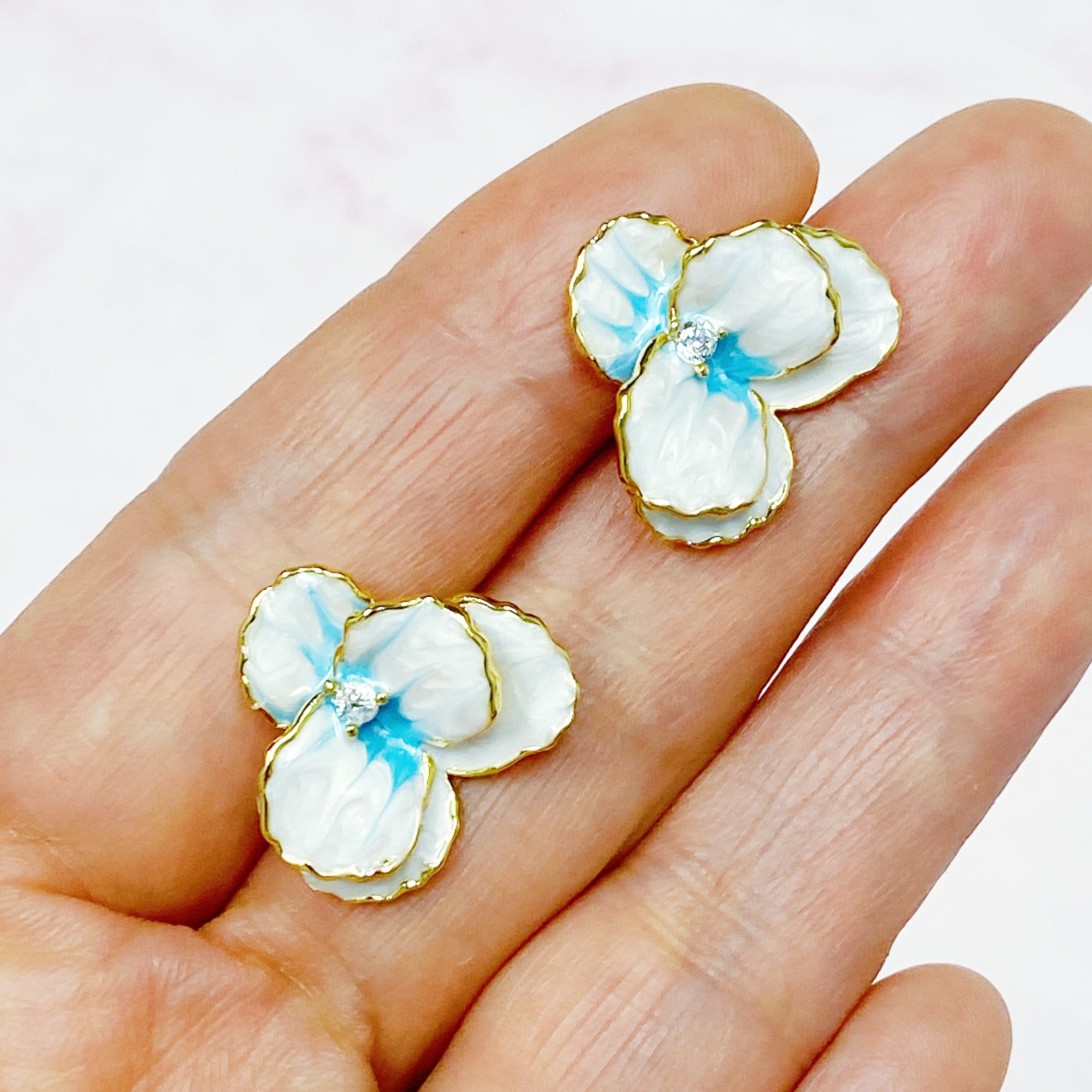 Noble Bloom Flower Earrings featuring white and blue enamel finish with 18K gold plated brass.