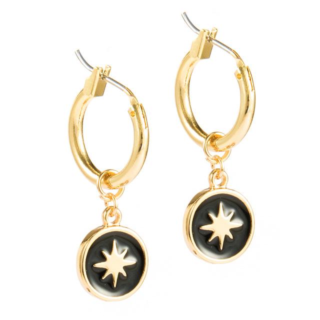 Elegant North Star Dangle Earrings with gold plating and ceramic inlay, showcasing their beautiful design and secure latch back closure.