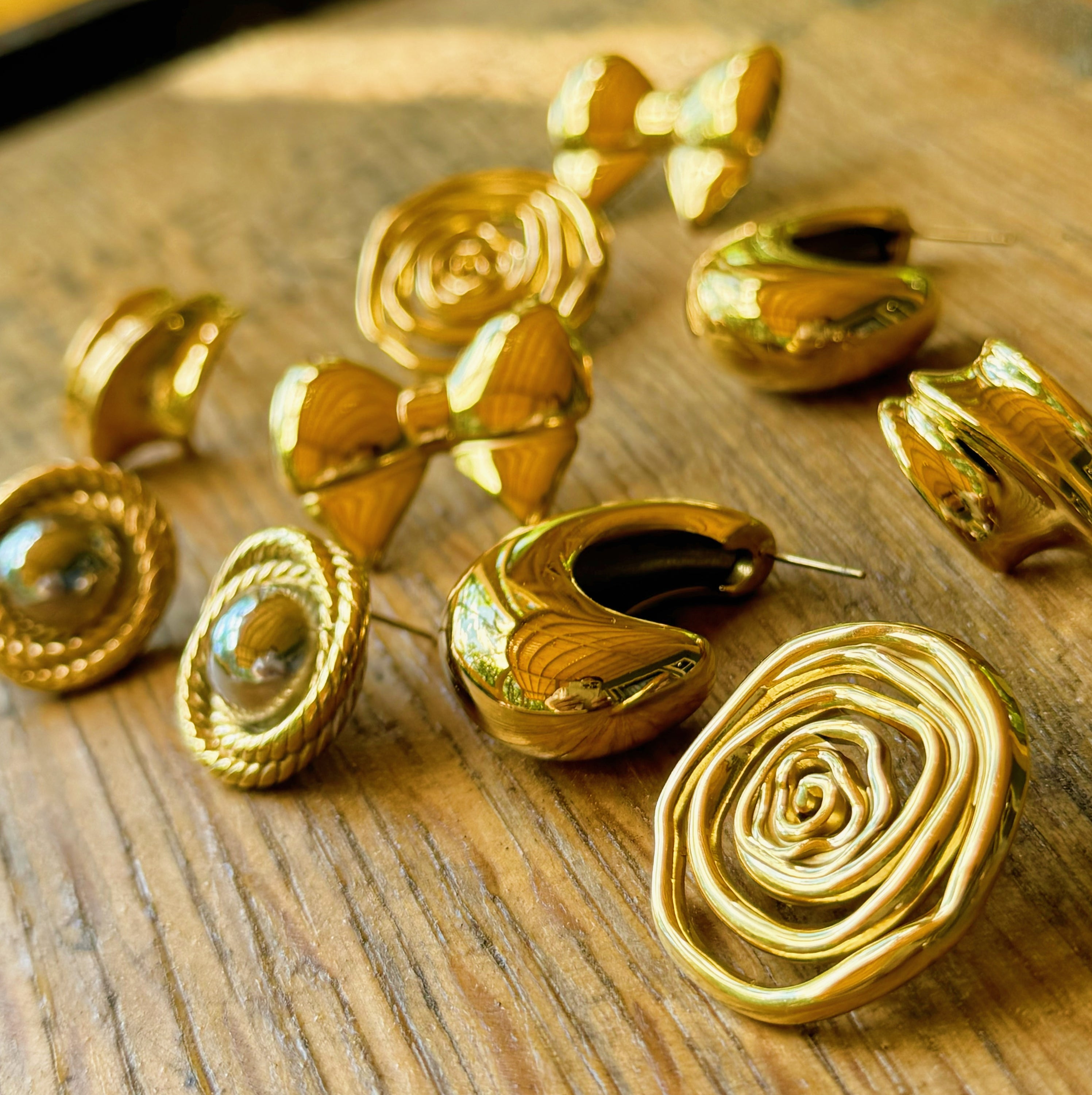 Elegant Oh My Gold Swirl Stud Earrings featuring a unique swirl design in 18k gold plating, perfect for any outfit.