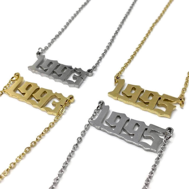 Old English Birth Year Necklace in stainless steel with customizable year and color options, featuring a 45cm chain and a 2.5 x 1cm pendant.