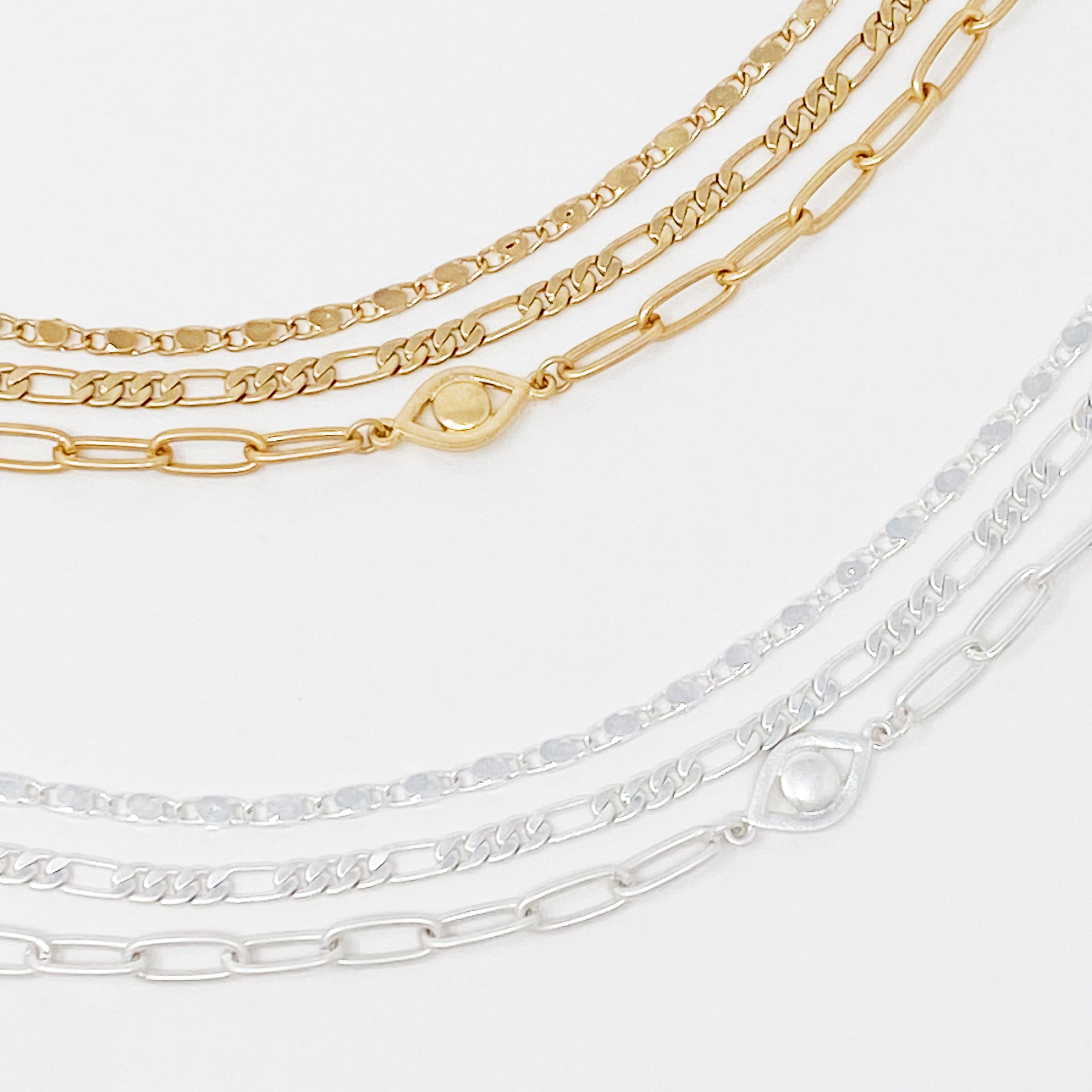 Set of three trendy chain anklets, featuring unique designs and adjustable lengths, perfect for layering or wearing alone.