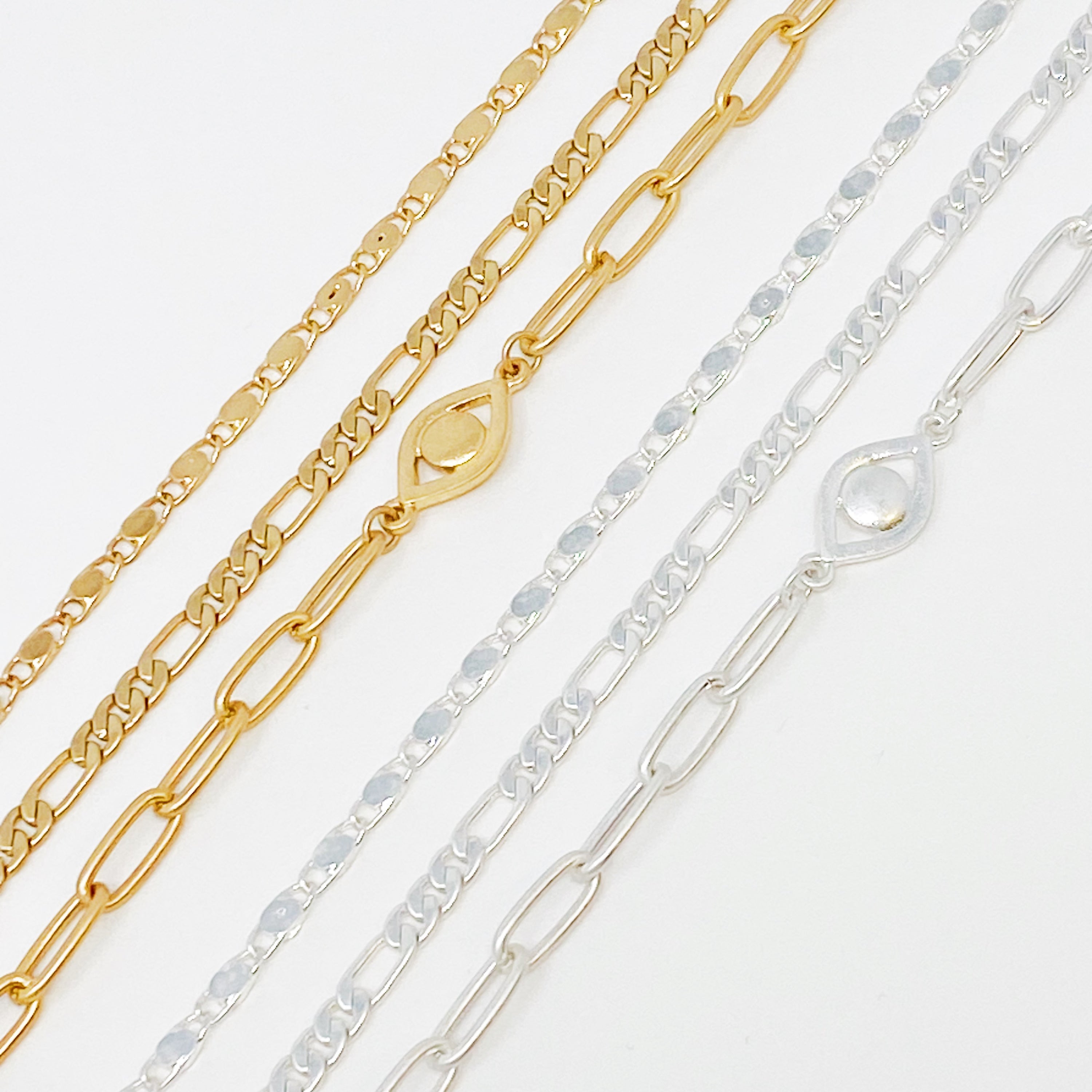 Set of three trendy chain anklets, featuring unique designs and adjustable lengths, perfect for layering or wearing alone.