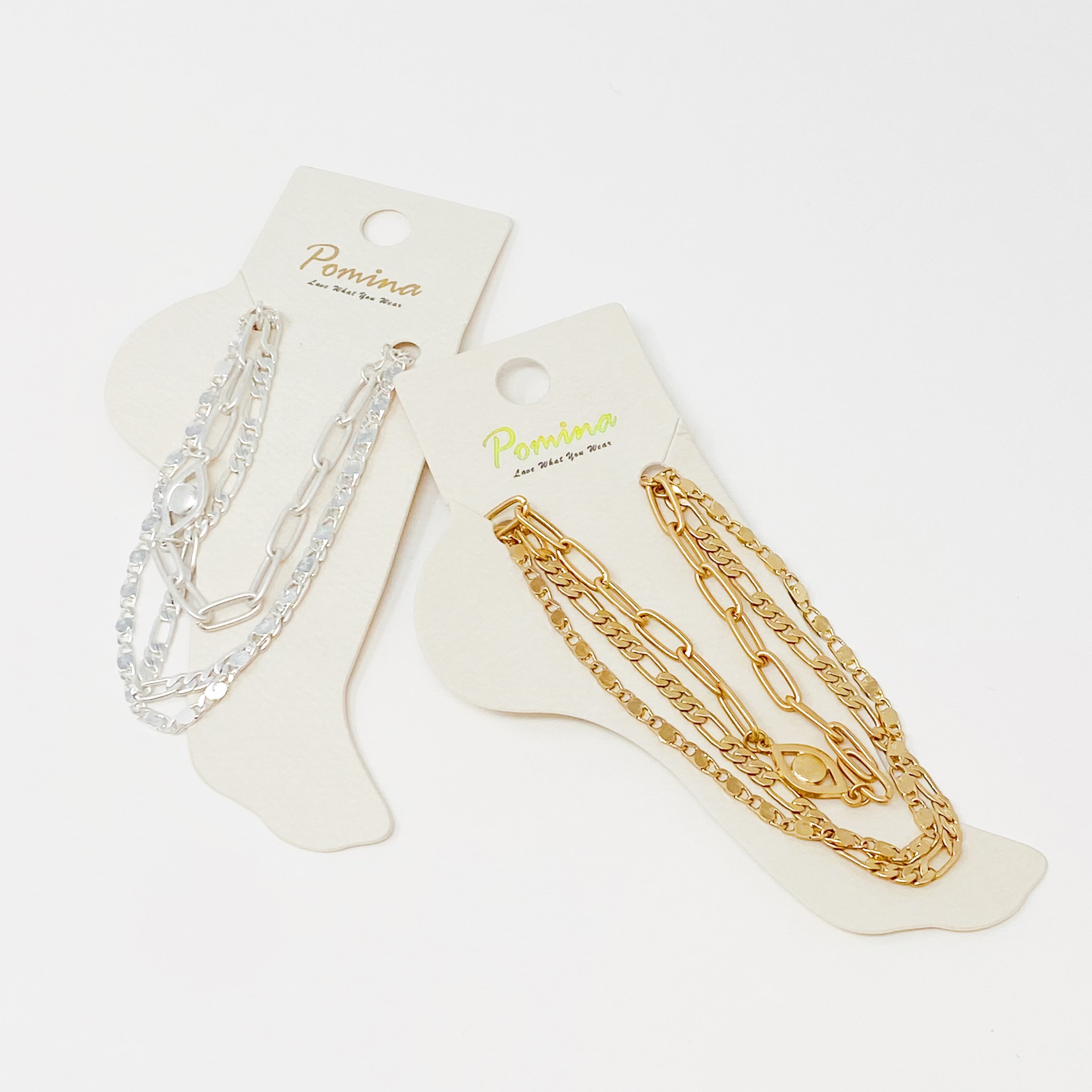 Set of three trendy chain anklets, featuring unique designs and adjustable lengths, perfect for layering or wearing alone.