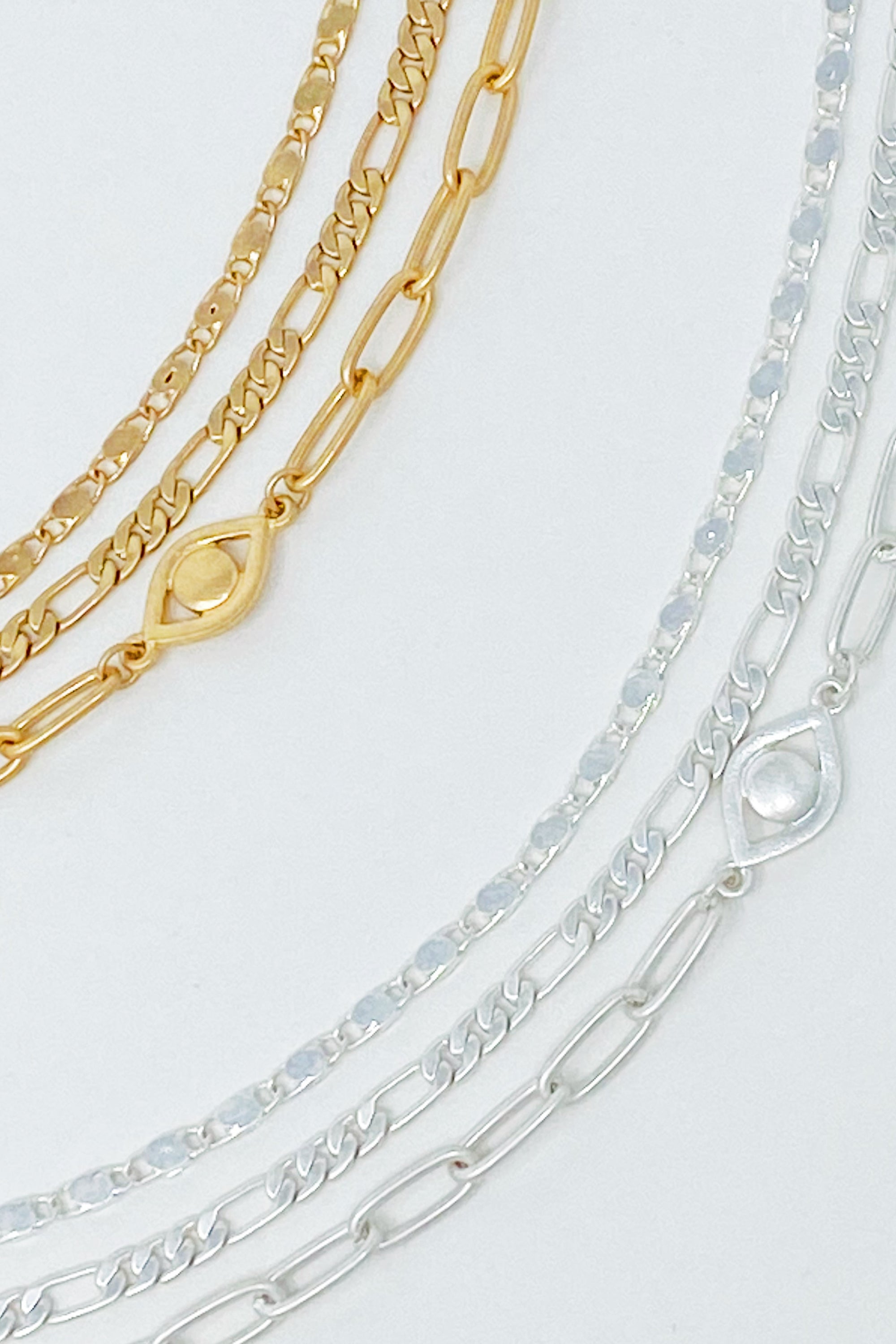 Set of three trendy chain anklets, featuring unique designs and adjustable lengths, perfect for layering or wearing alone.