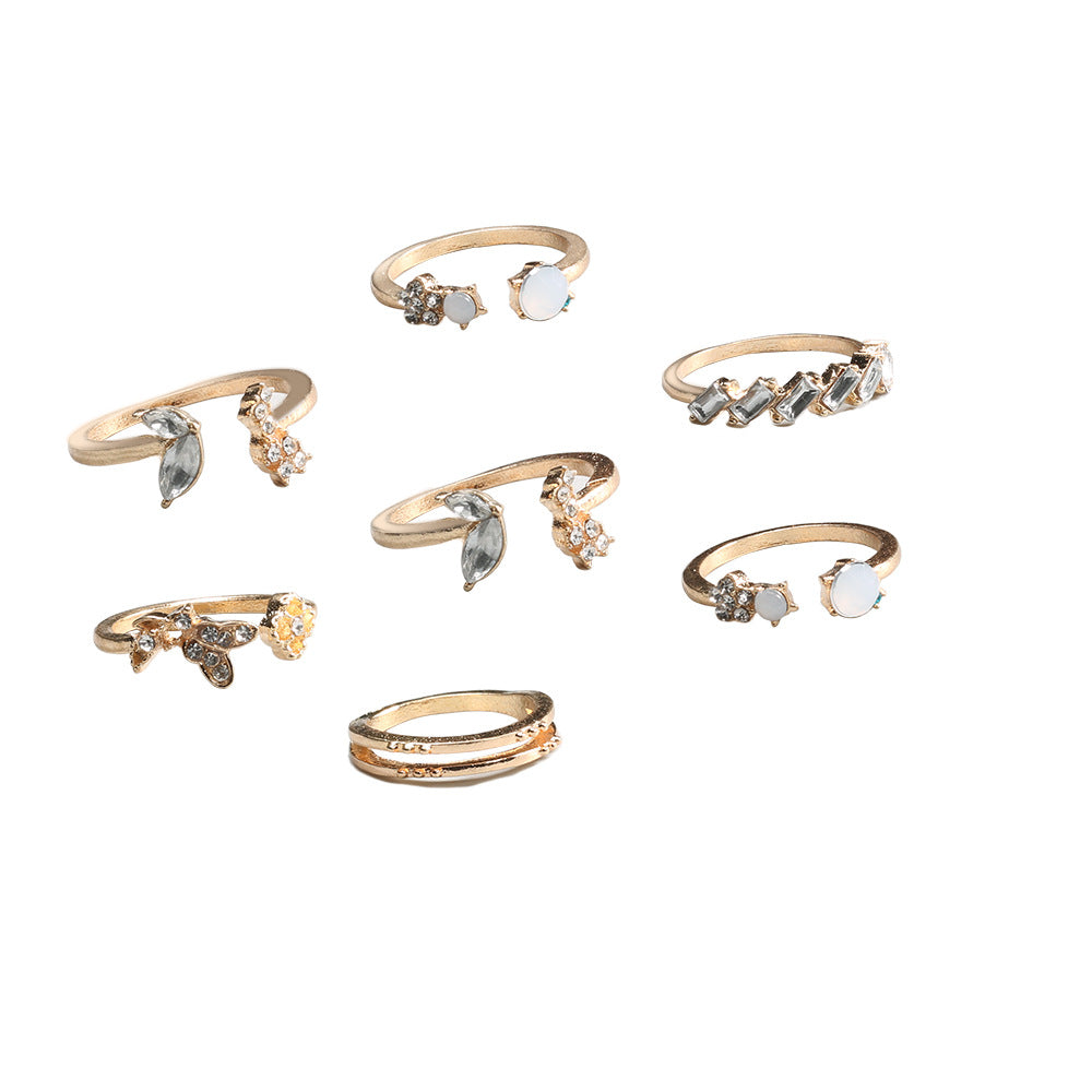 A beautiful 6-piece ring set featuring opal and butterfly crystals, crafted from 14K gold plated brass.