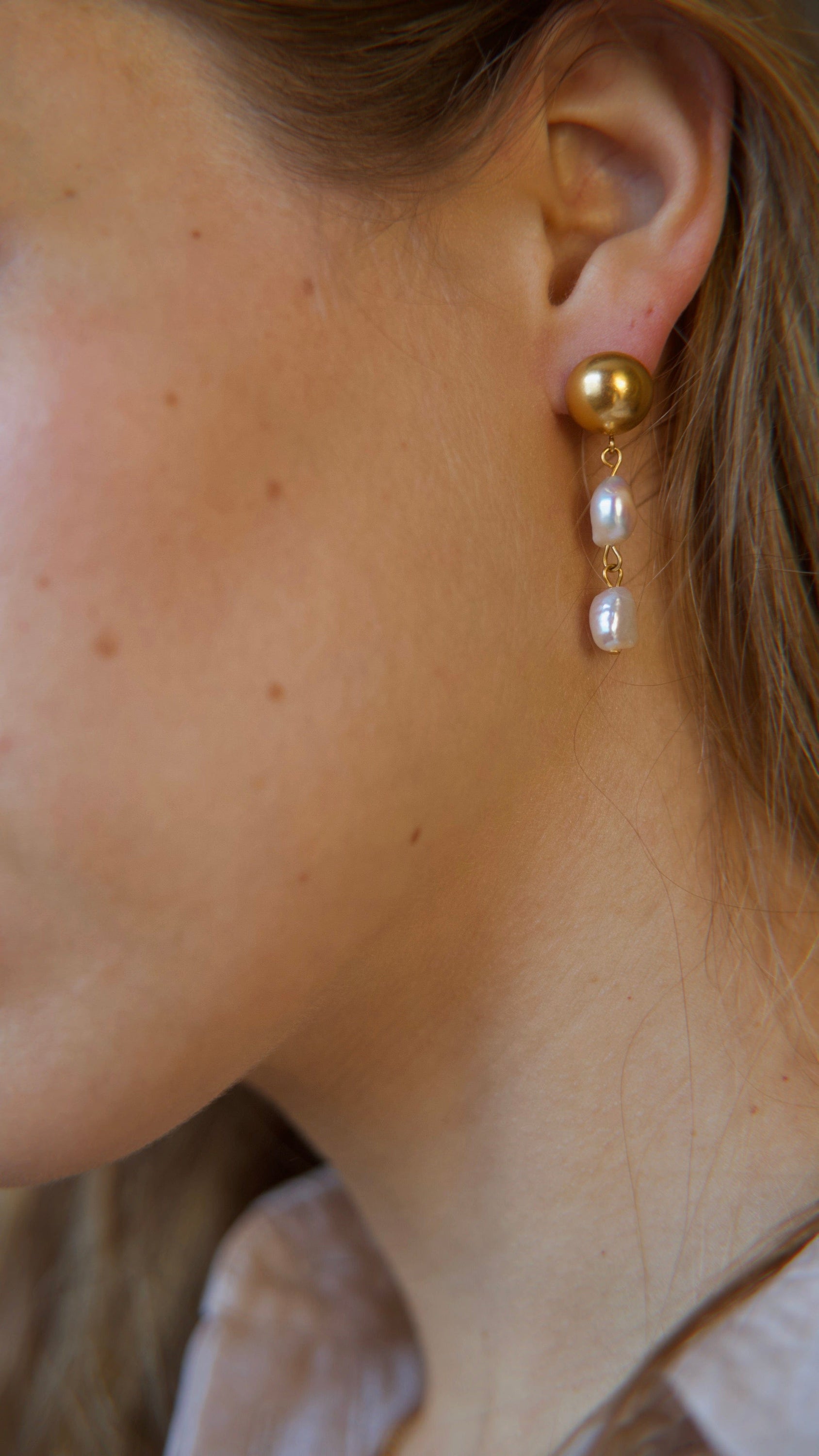 Elegant Orra - Long baroque pearl earrings with chunky stainless steel design and 18K gold plating.