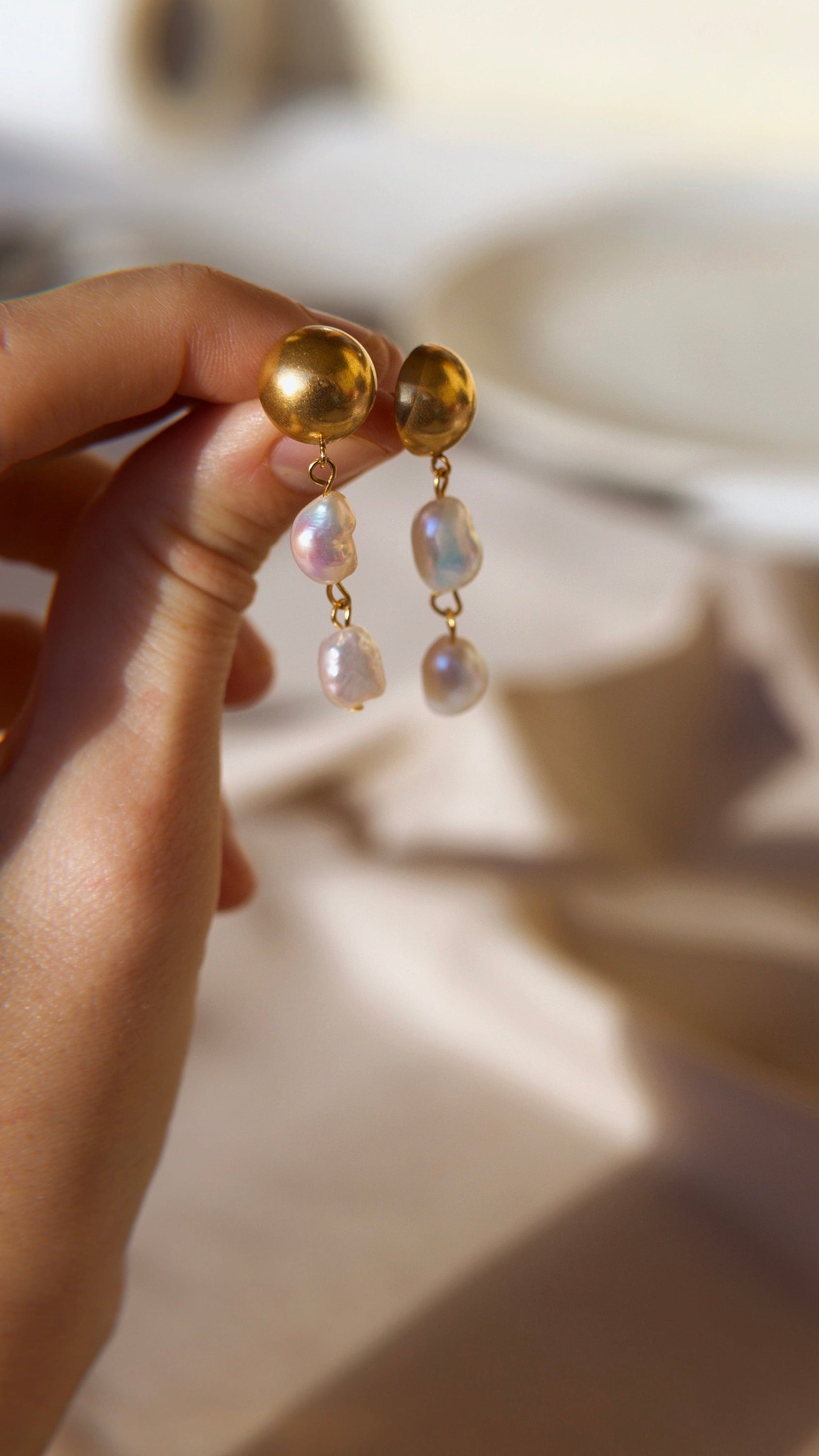 Elegant Orra - Long baroque pearl earrings with chunky stainless steel design and 18K gold plating.