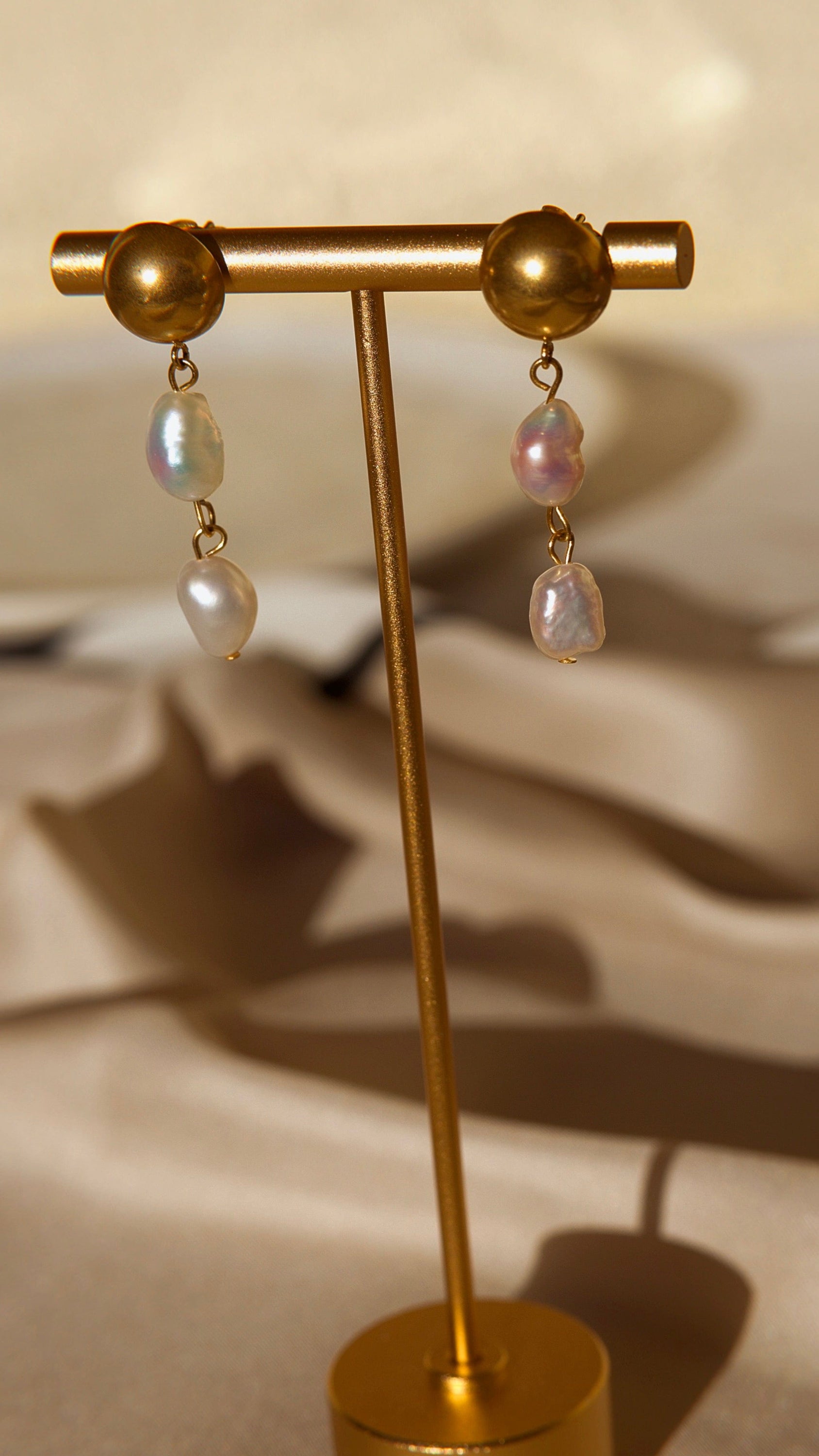 Elegant Orra - Long baroque pearl earrings with chunky stainless steel design and 18K gold plating.