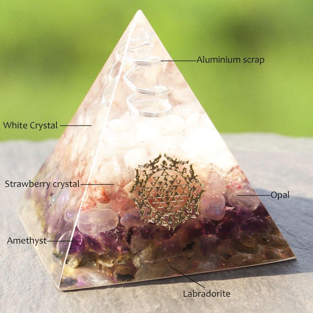 Orgone pyramid featuring clear white crystal point and strawberry crystal, handcrafted with natural stones for energy protection and decor.