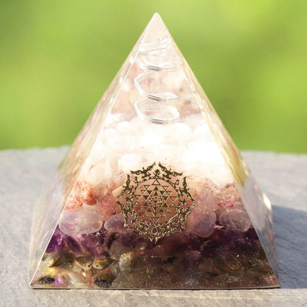 Orgone pyramid featuring clear white crystal point and strawberry crystal, handcrafted with natural stones for energy protection and decor.