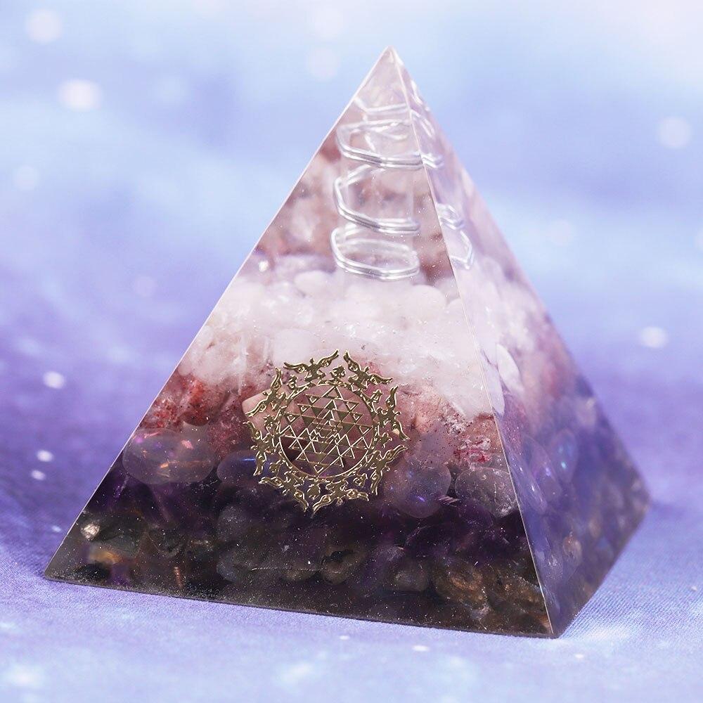 Orgone pyramid featuring clear white crystal point and strawberry crystal, handcrafted with natural stones for energy protection and decor.