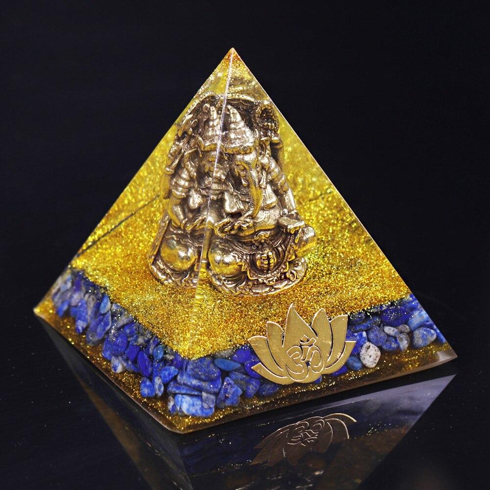 A handcrafted Orgone Pyramid featuring a Copper Ganesha design, made with natural Lapis Lazuli and resin, measuring 8cm in all dimensions.