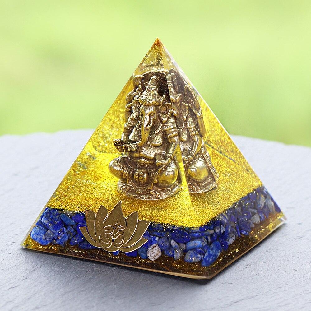 A handcrafted Orgone Pyramid featuring a Copper Ganesha design, made with natural Lapis Lazuli and resin, measuring 8cm in all dimensions.