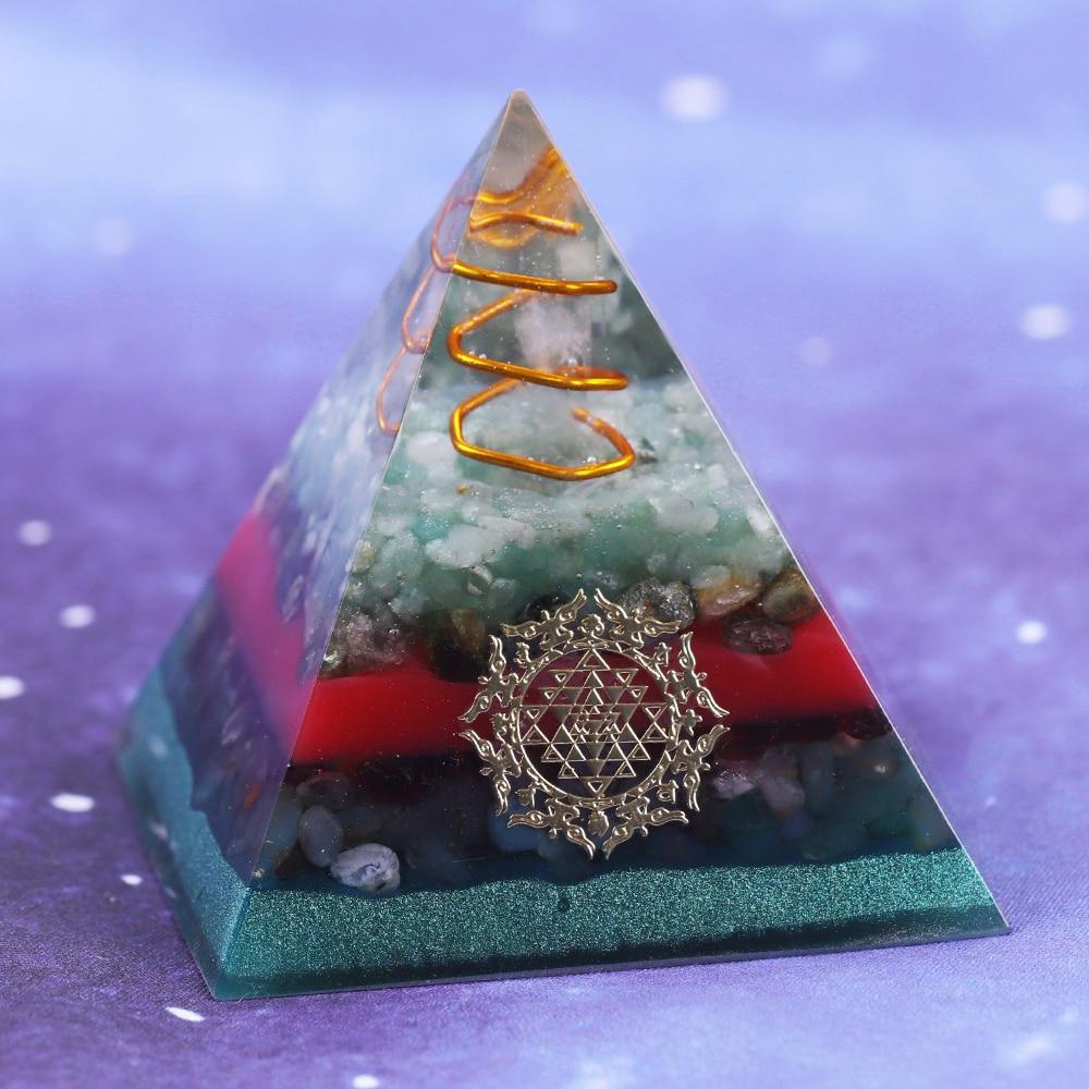 A handcrafted Orgonite Pyramid made from green aventurine, copper, olivine, green agate, and garnet, designed for chakra healing and energy conversion.